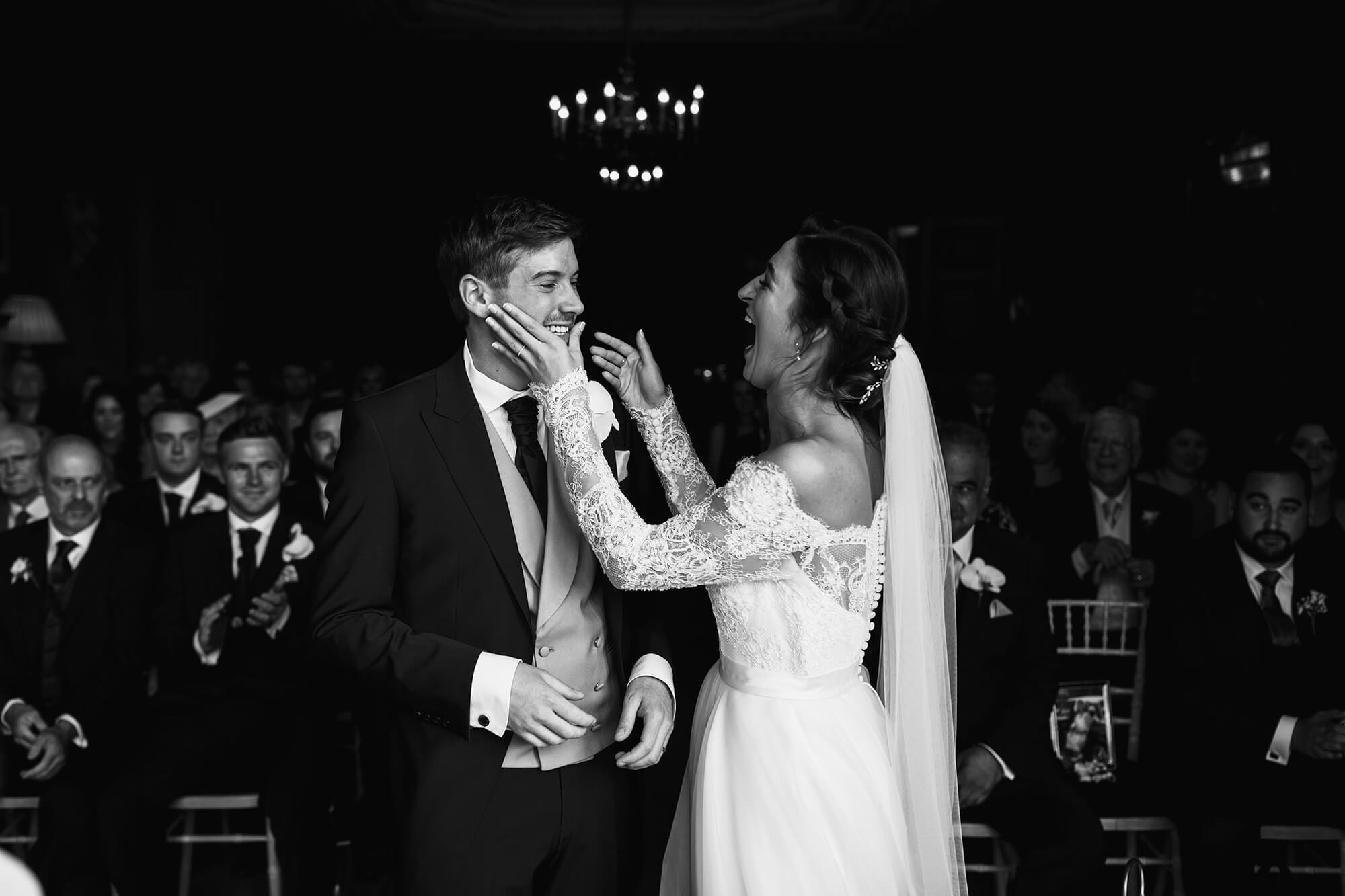 Bride and groom smiling at each other at ceremony Thornton Manor House