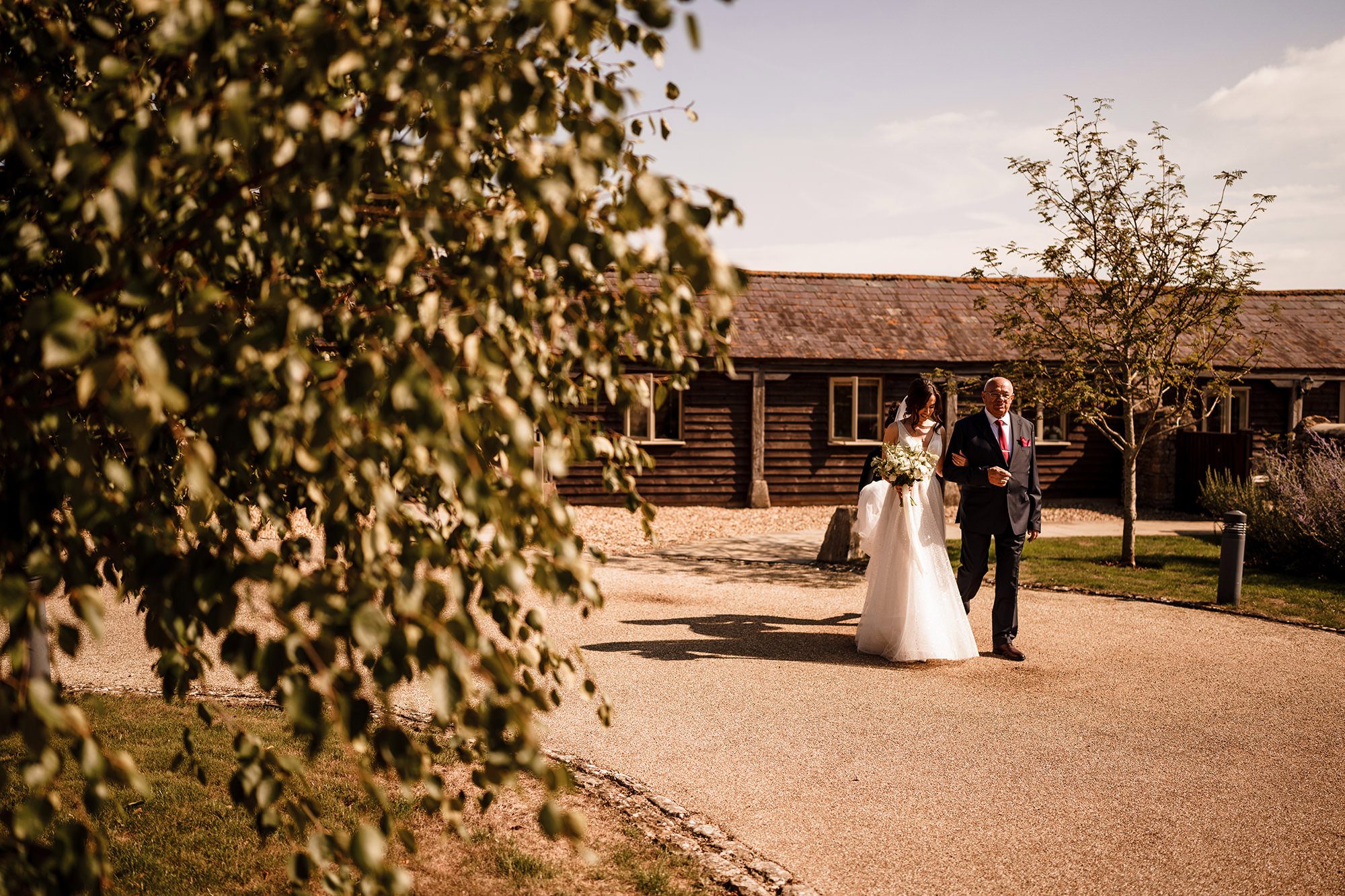 bride and her father walking to the entrance of Caswell House