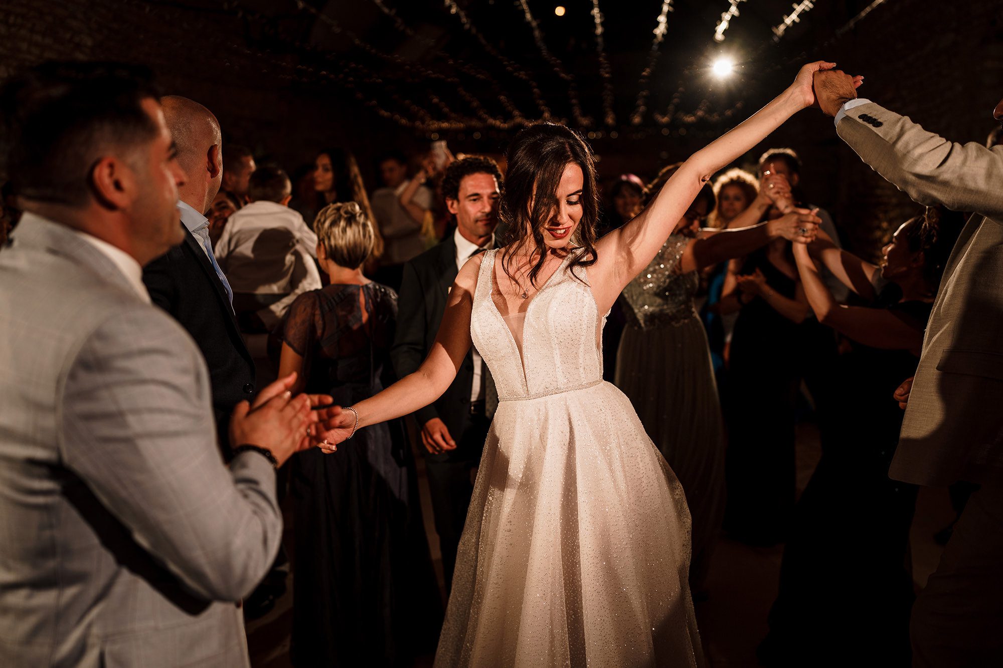 bride dancing with her wedding guests at her own wedding 