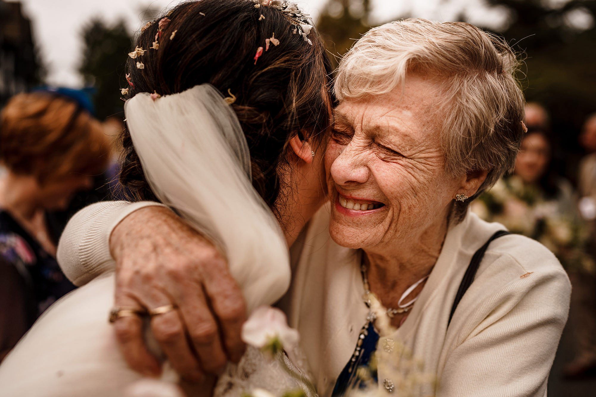 elderly relative hugs bride after wedding ceremony