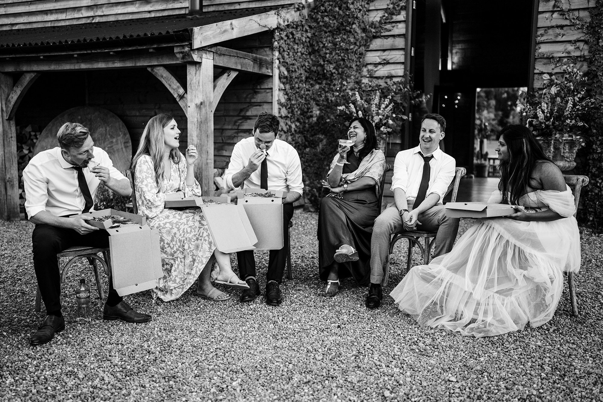 wedding guests sit outside Lake District wedding venue