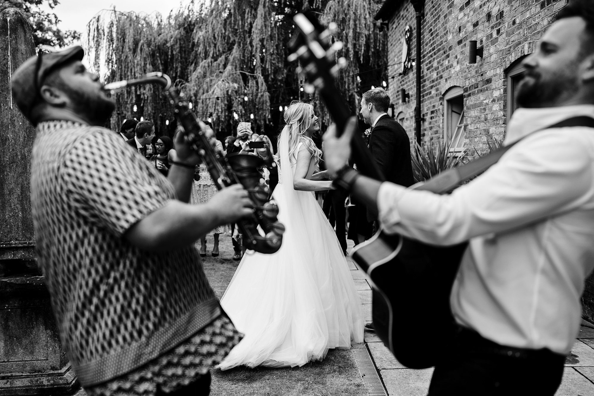 couple dance in front of guitars in London gardens