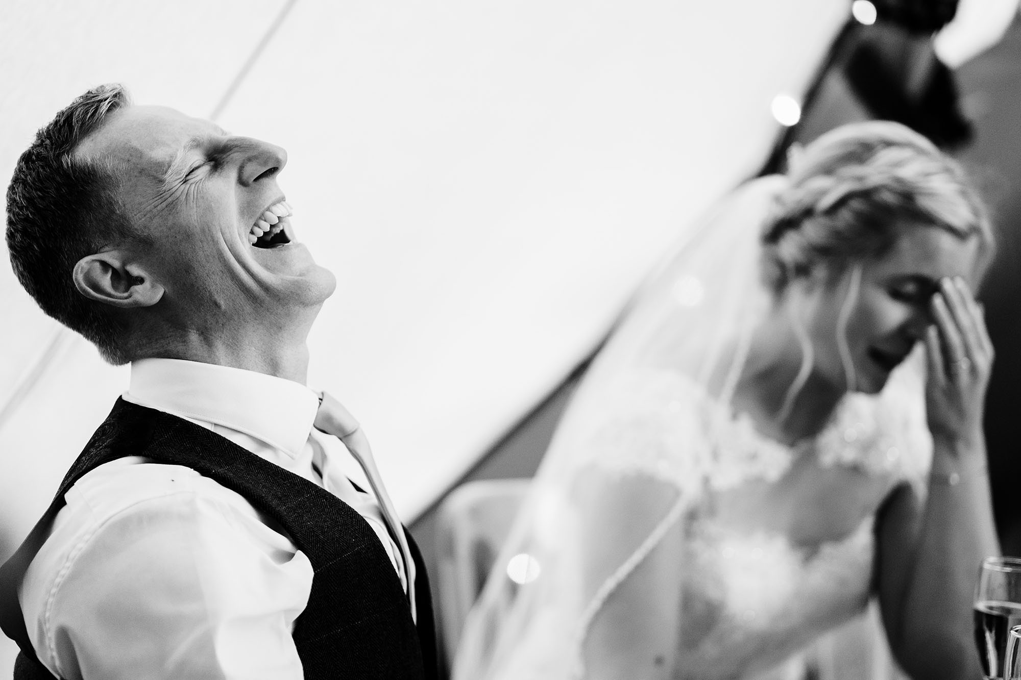 groom laughs at best mans joke during London wedding