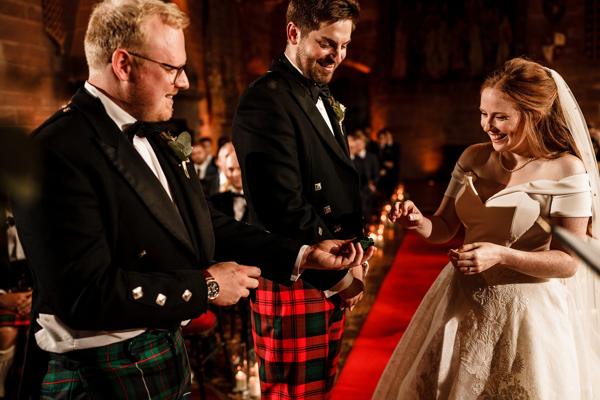 best man hands over the wedding rings to the bride at Peckforton castle