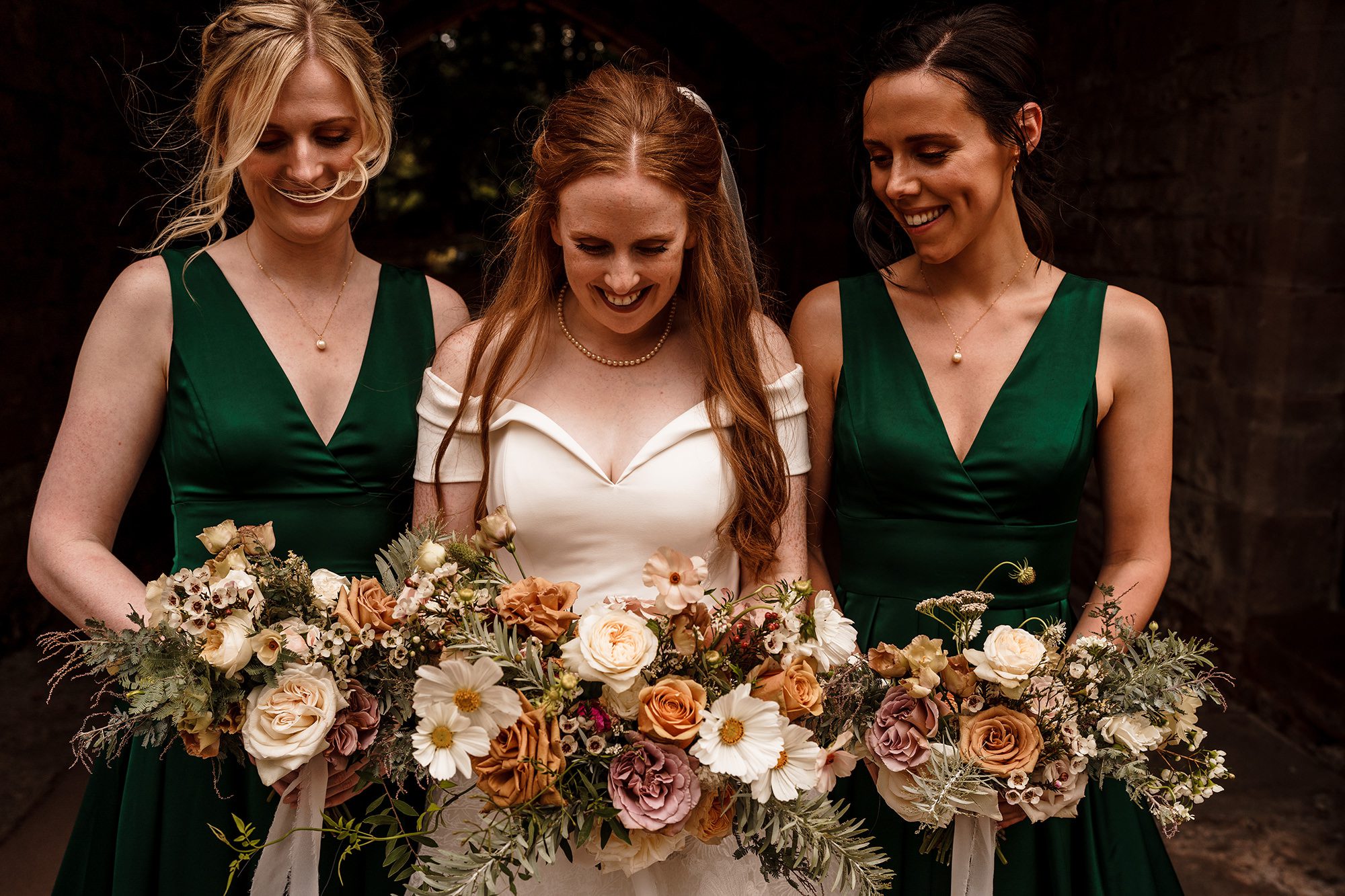bride and her bridesmaids at the gates of Peckforton Castle 