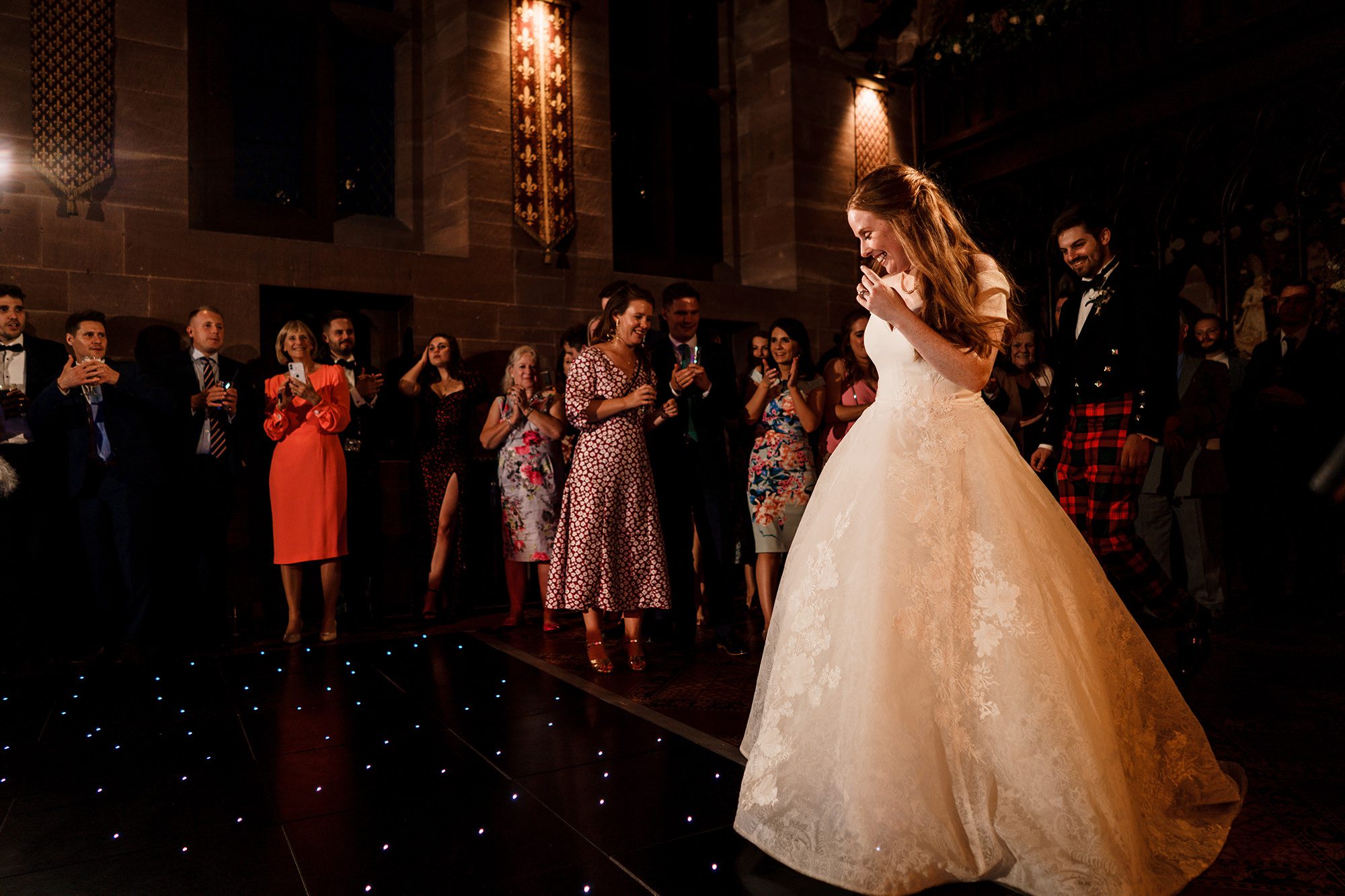 bride walks onto the dance floor for her first dance at Peckforton Castle