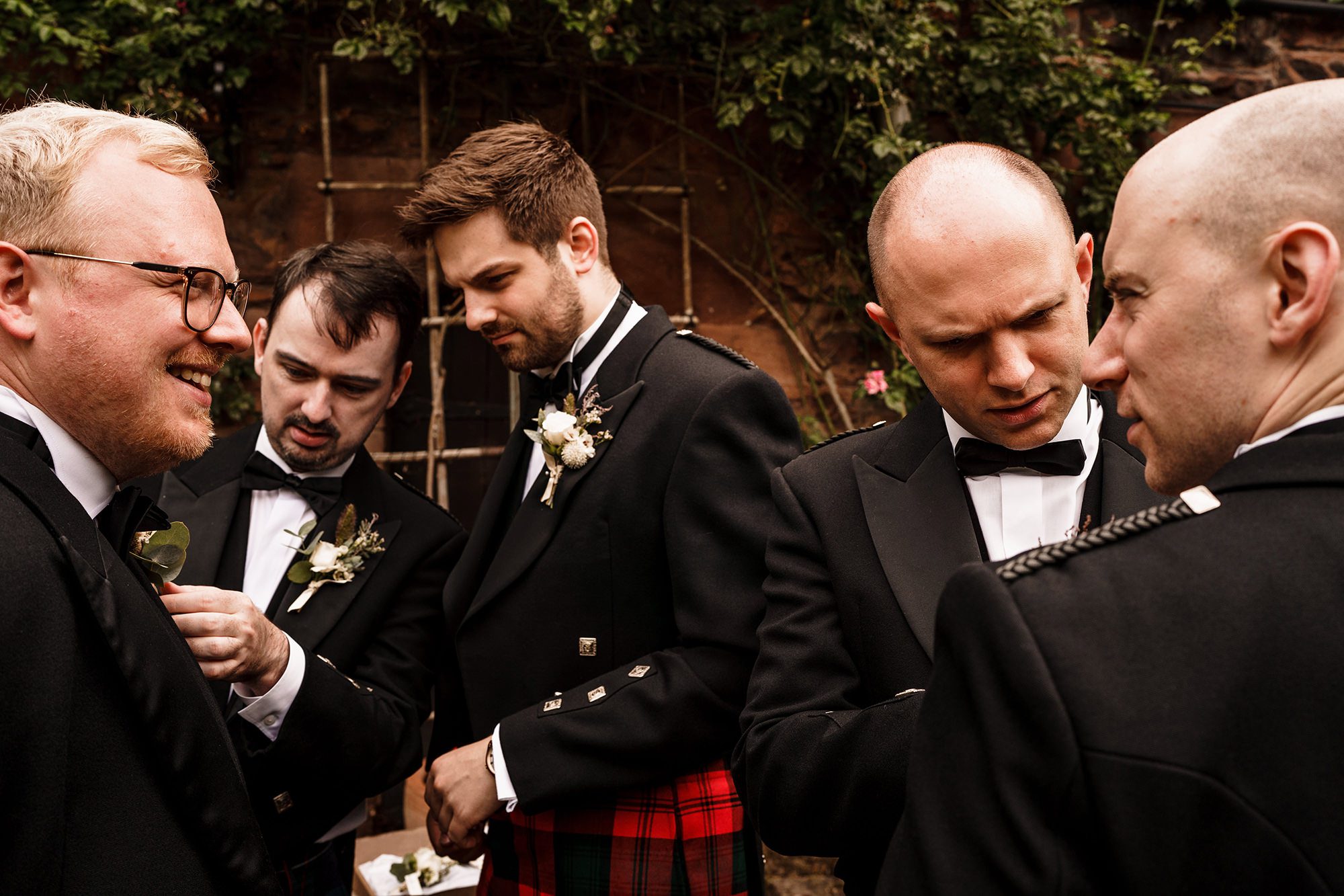groomsmen at Peckforton Castle checking over one another