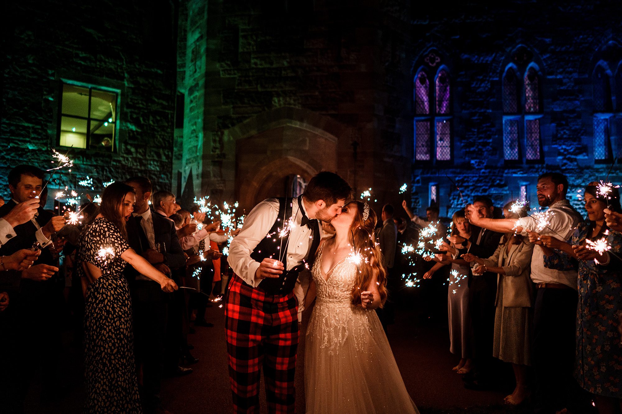Bride and groom with sparklers at Peckforton Castle 