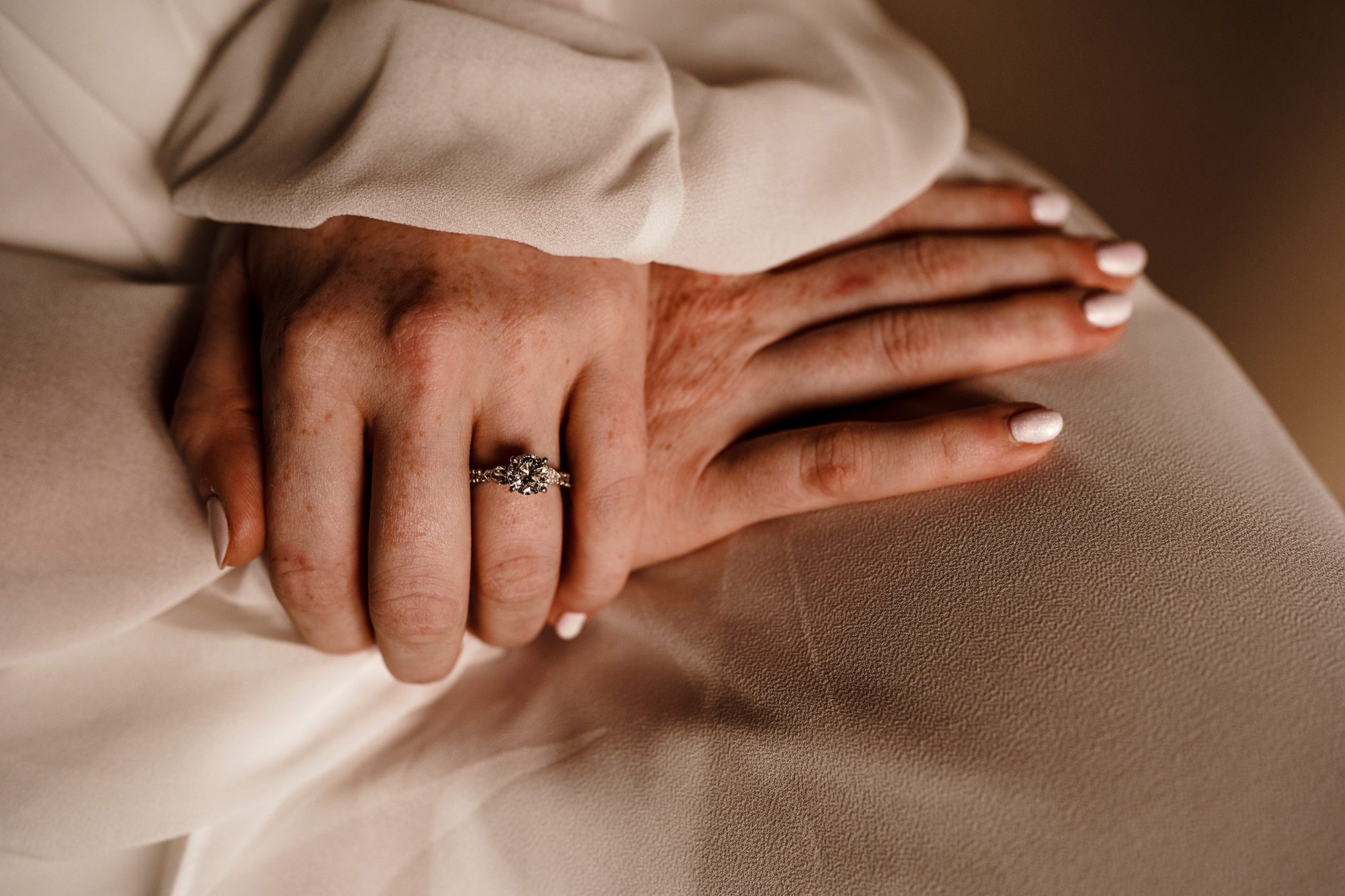 brides engagement ring on her wedding finger