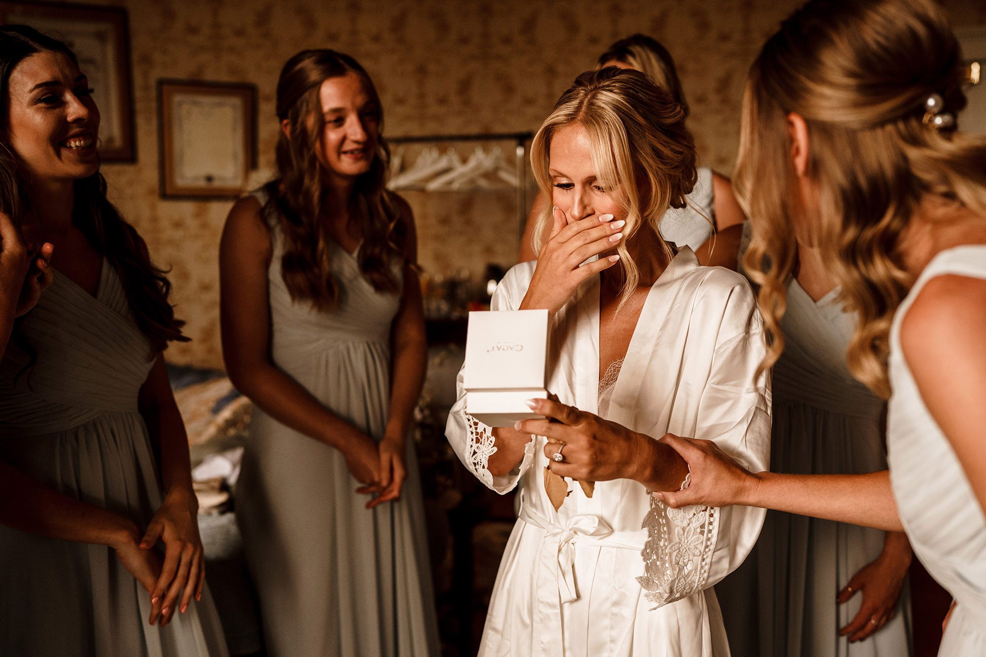 candid moment of bride opening up her wedding gift