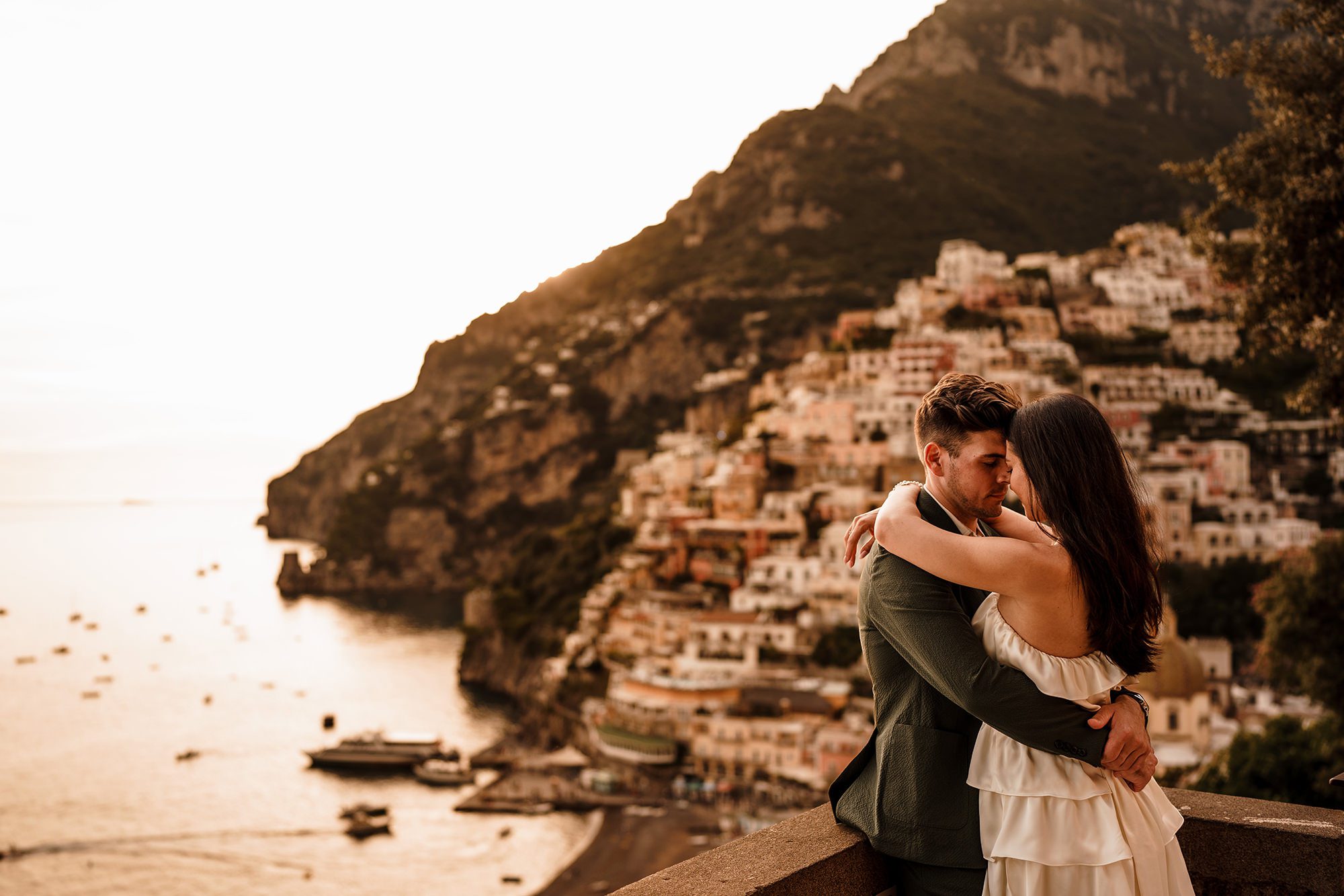 eloping couple in Italy with Positano in the background