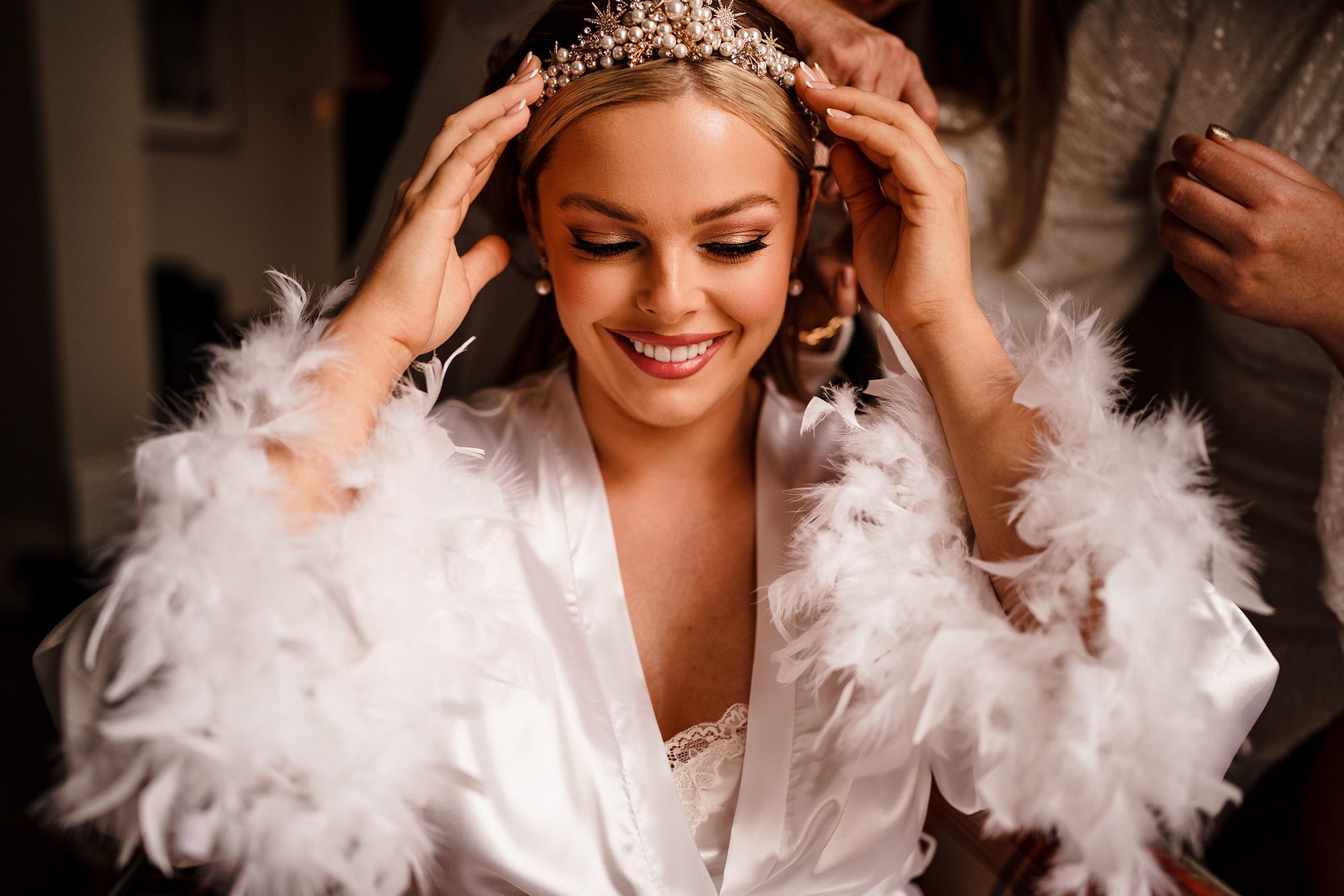 bride adjusts her headdress for granary estates wedding