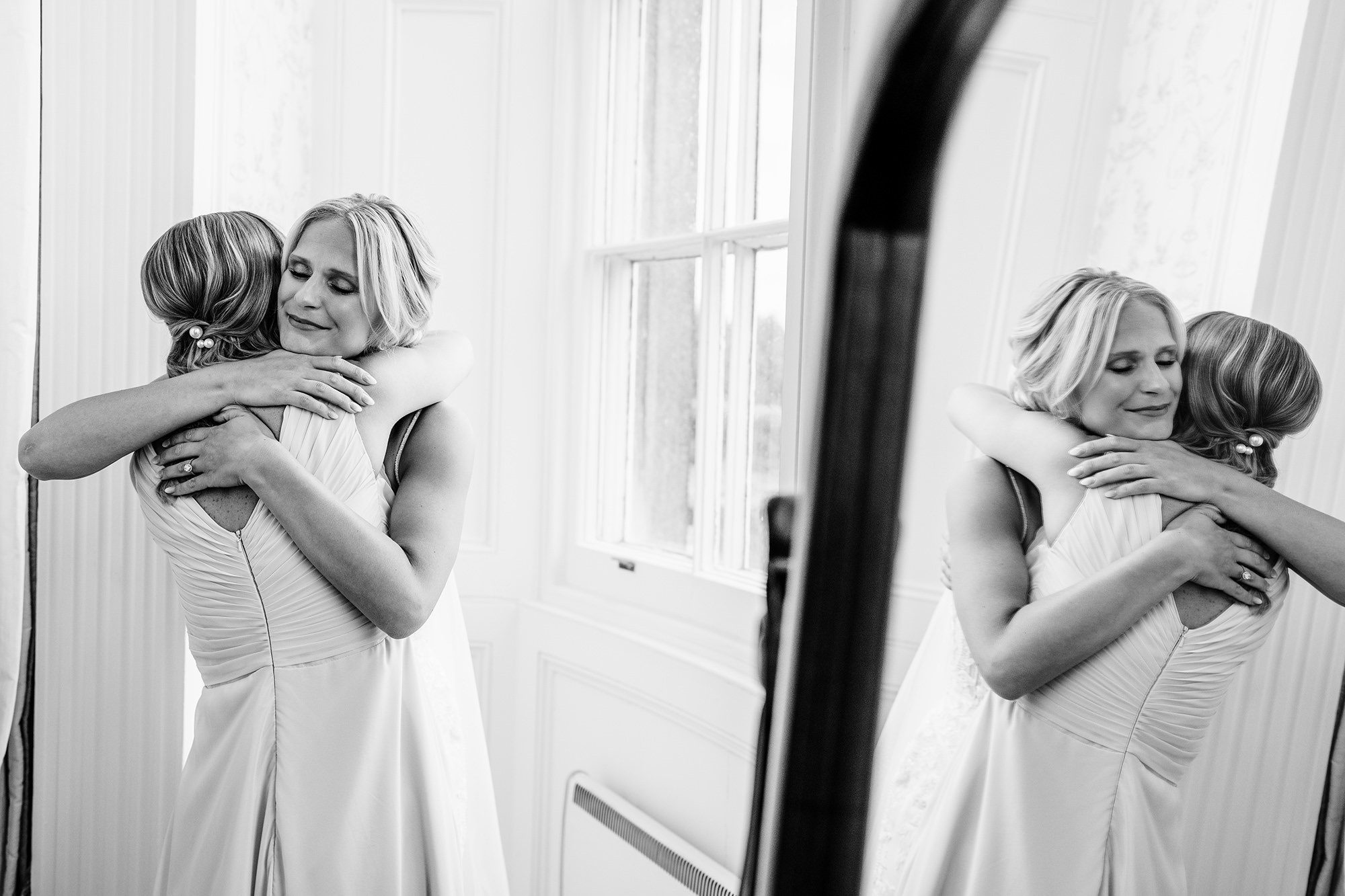 bride hugs her sister emotionally before wedding