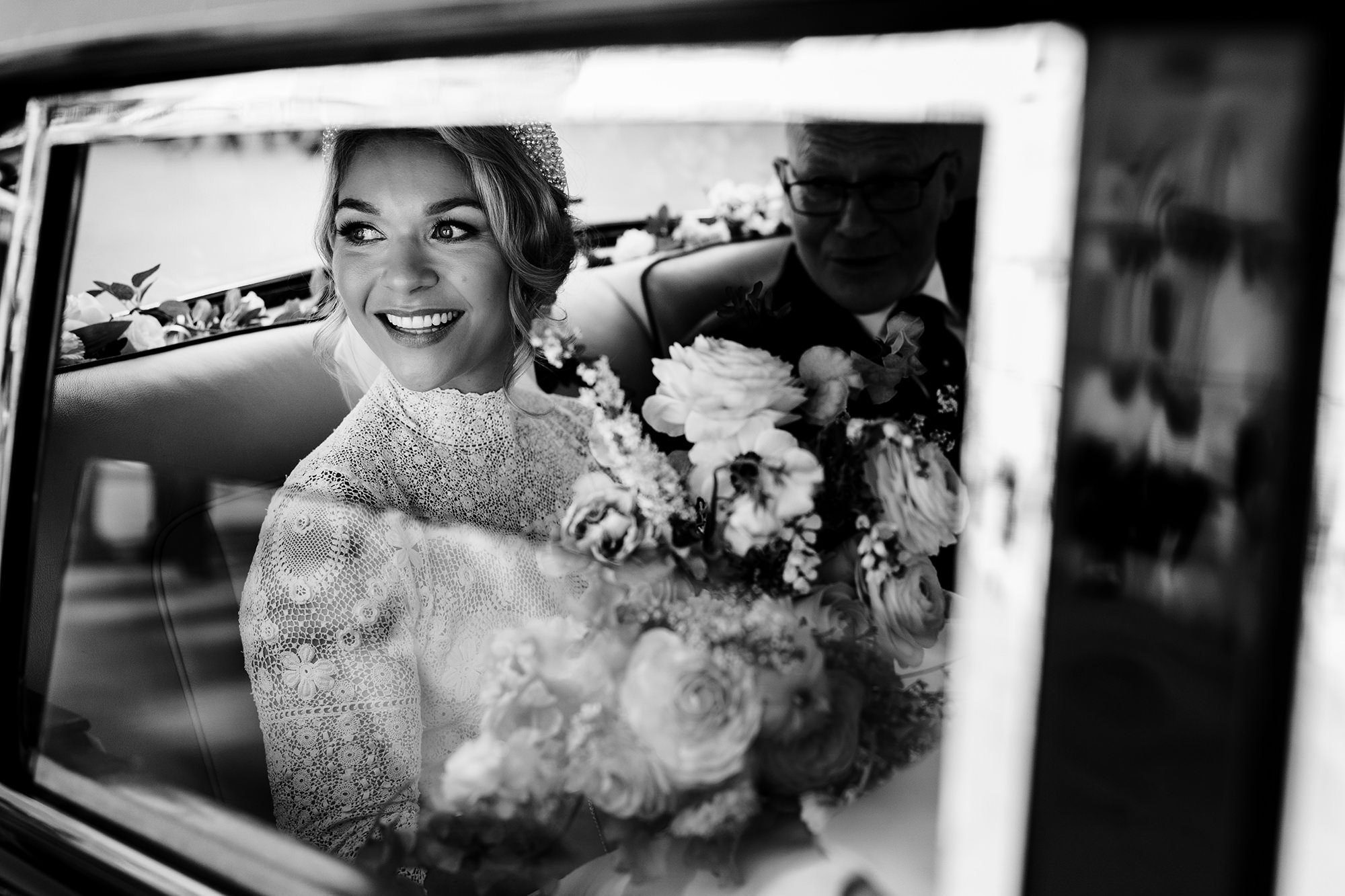 bride looks out of car in timeless black and white