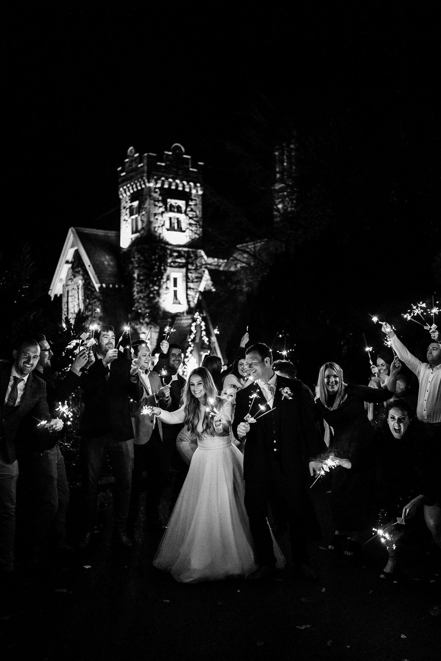 bridal party with sparklers at this West Tower Winter Wedding
