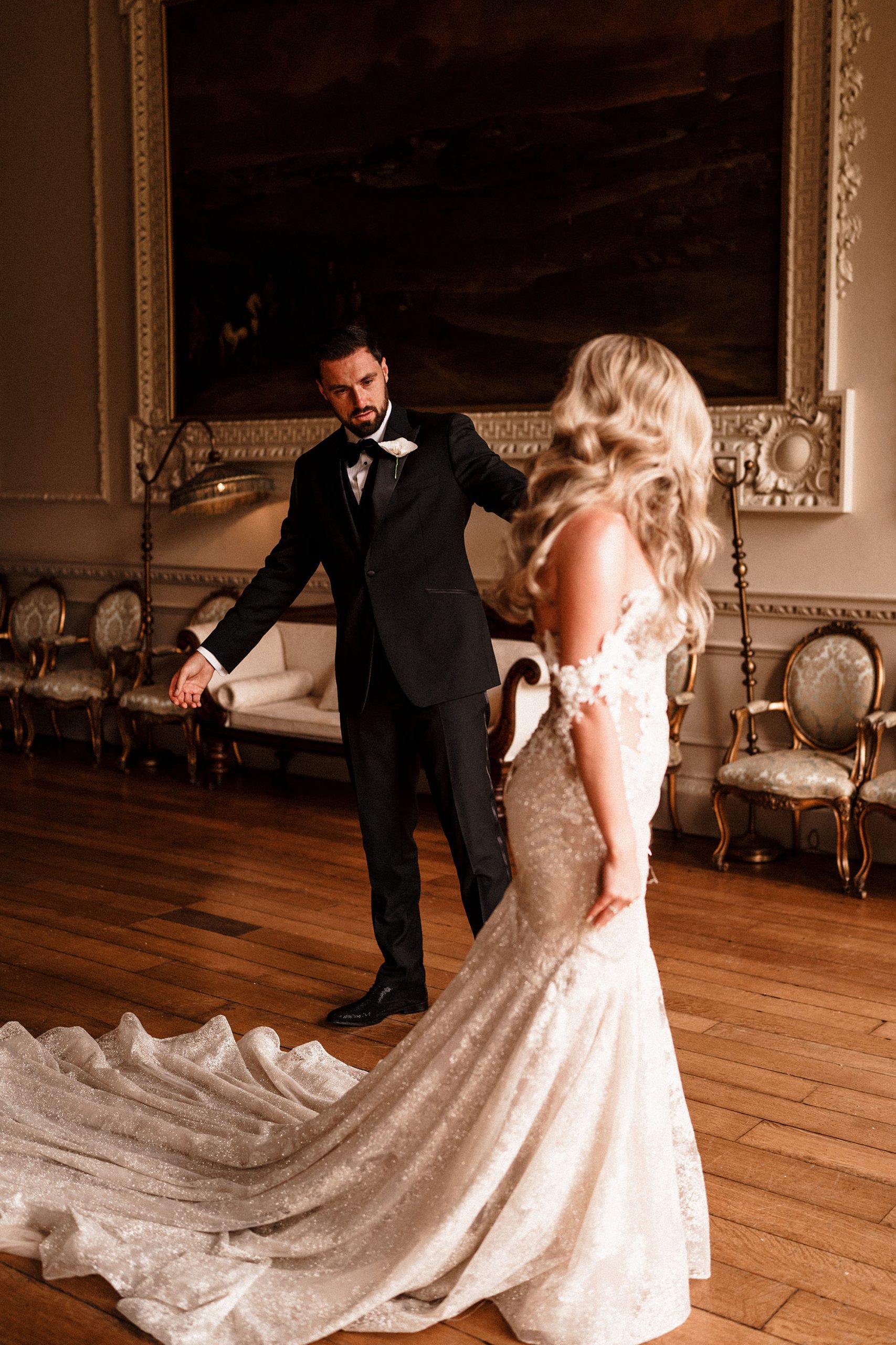 bride showing off her wedding dress to her groom at Hawkstone Hall