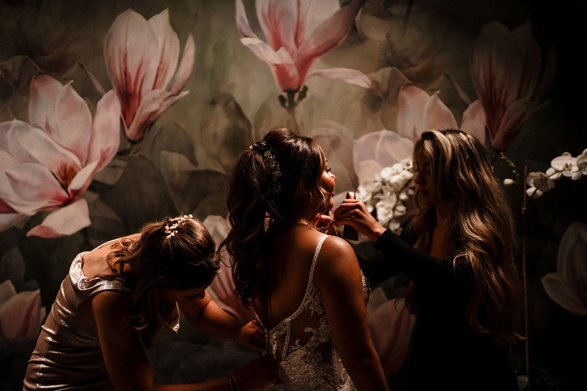 bride getting fussed over in Woodhill hall wedding photos