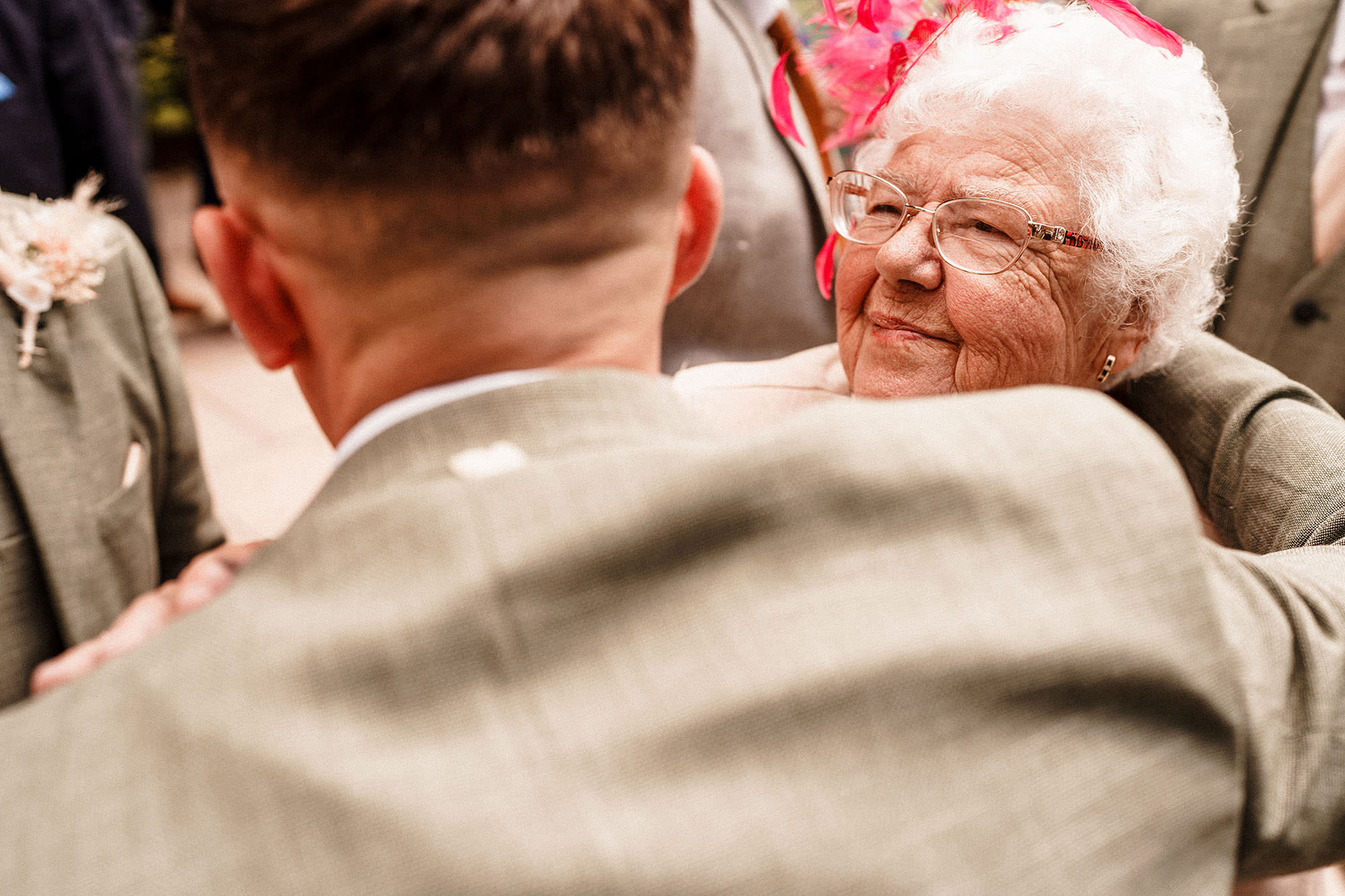 groom hugs grandma on wedding day