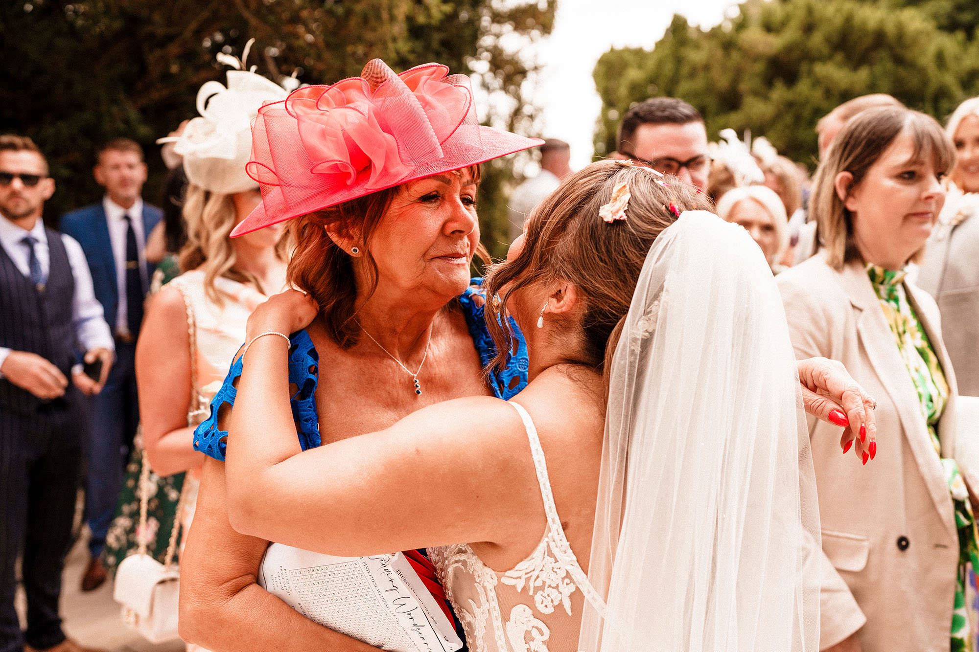 hugs with guests on wedding day