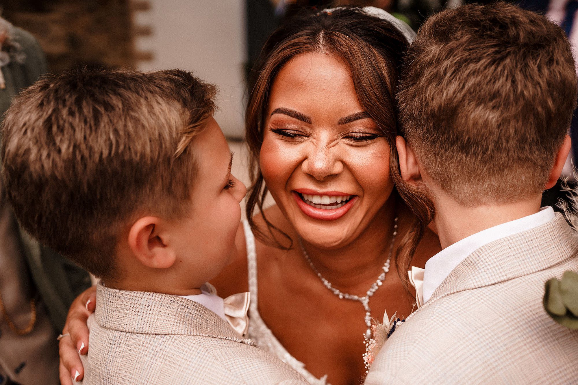 bride with some children on her wedding day at woodhill hall