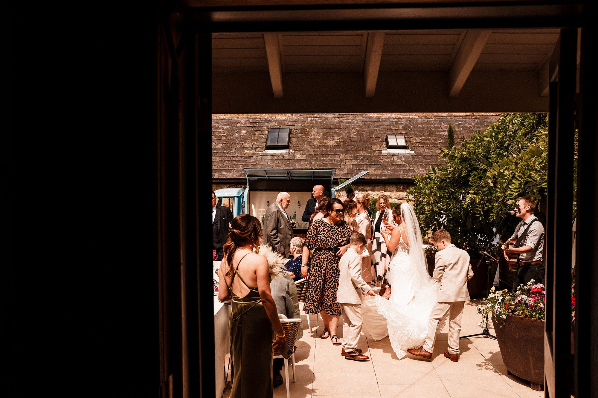 wedding guests enjoying there time in the sunshine at woodhill hall
