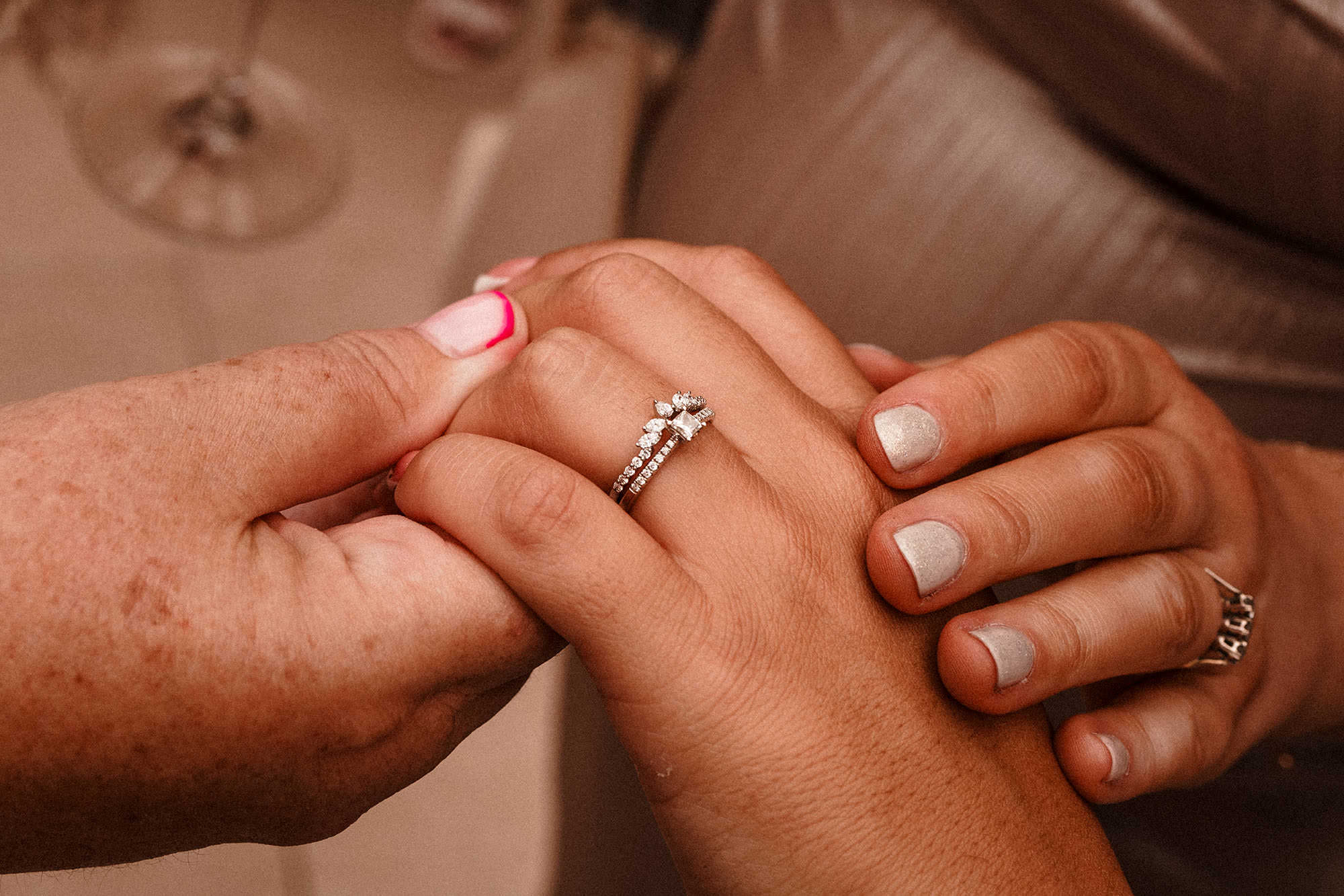 people admiring the brides wedding ring