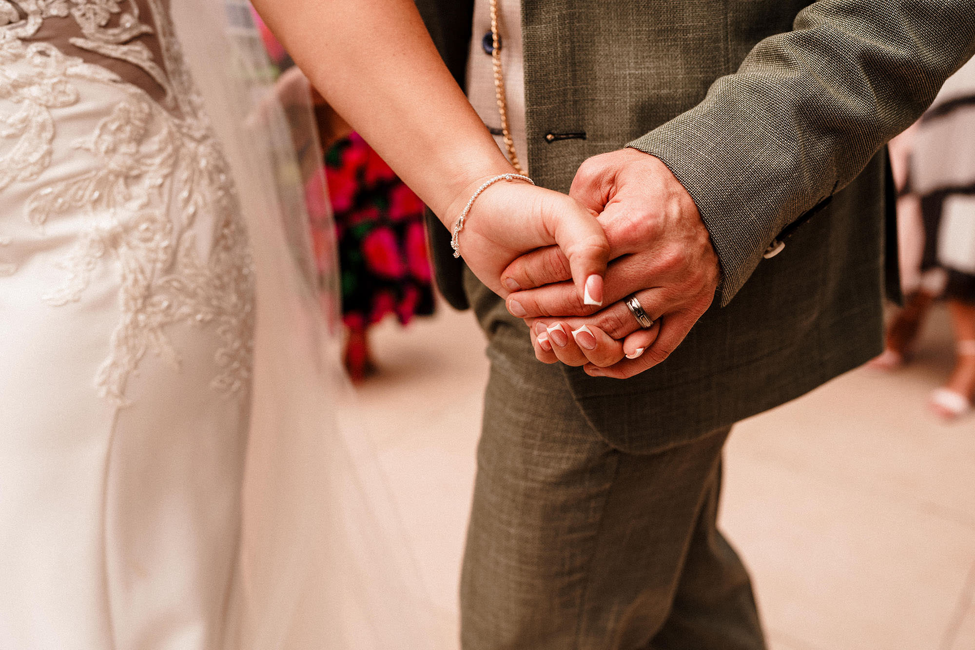 bride and groom holding hands