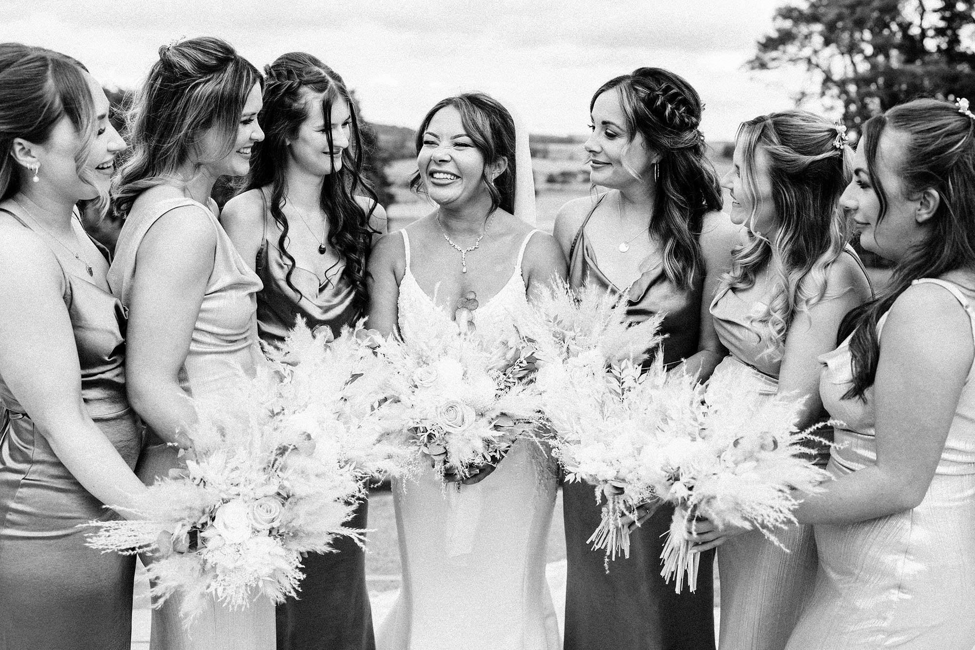bride and bridesmaids posing for woodhill hall wedding photo