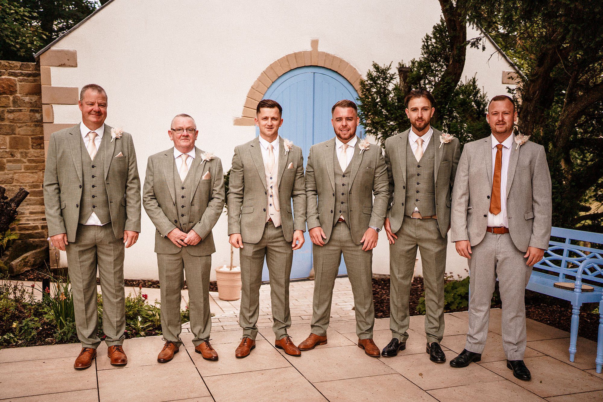 groomsmen stood outside ceremony room at Woodhill hall
