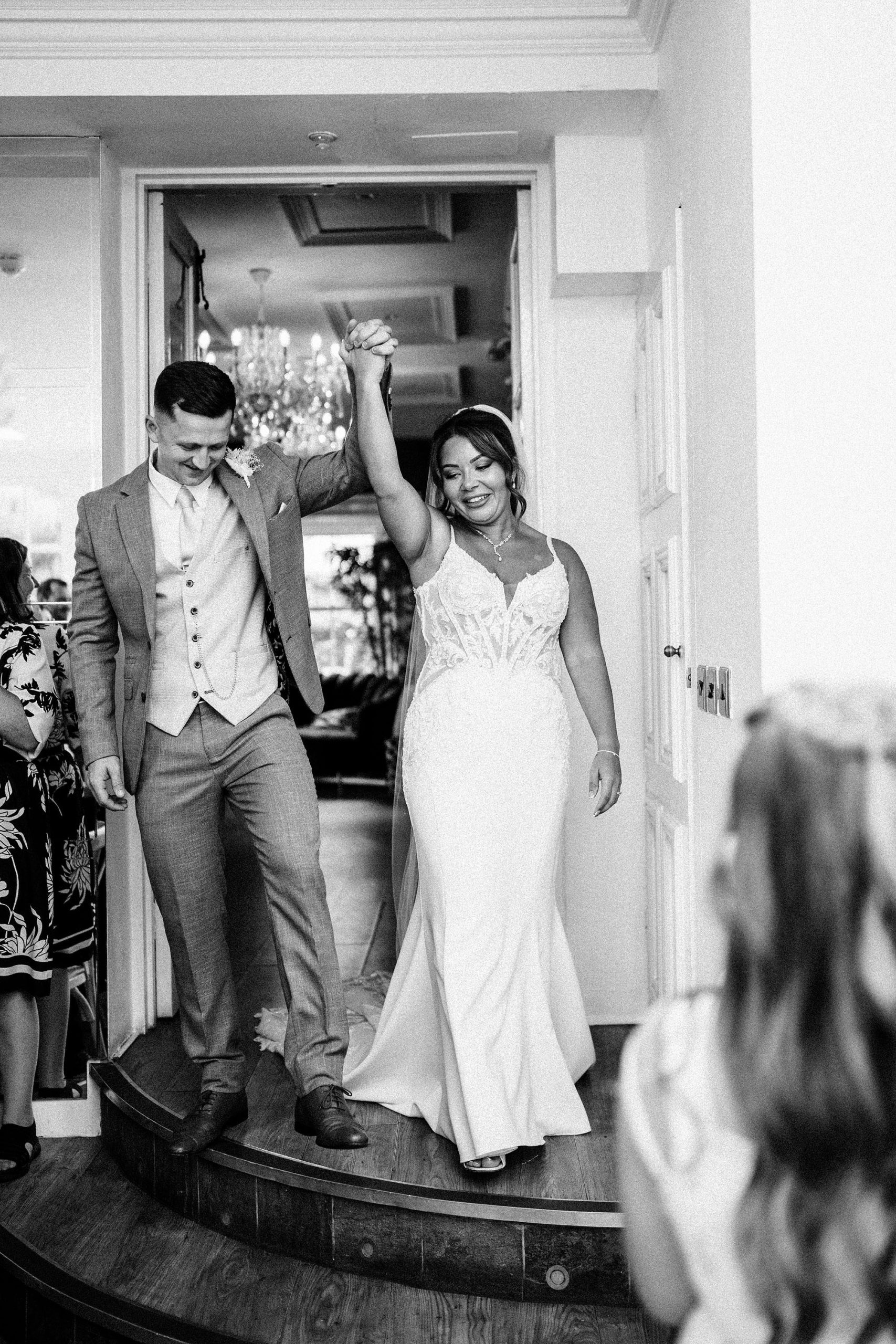 bride and groom celebrate coming in to the room at woodhill hall