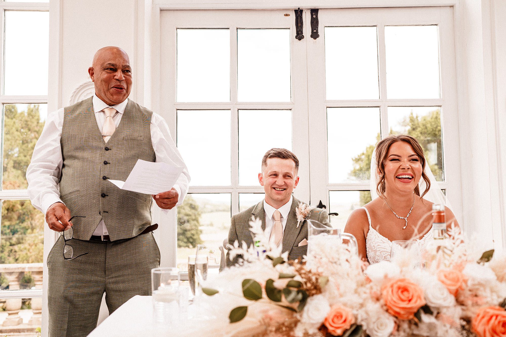 bride and groom react to father of the bride speech at woodhill hall wedding