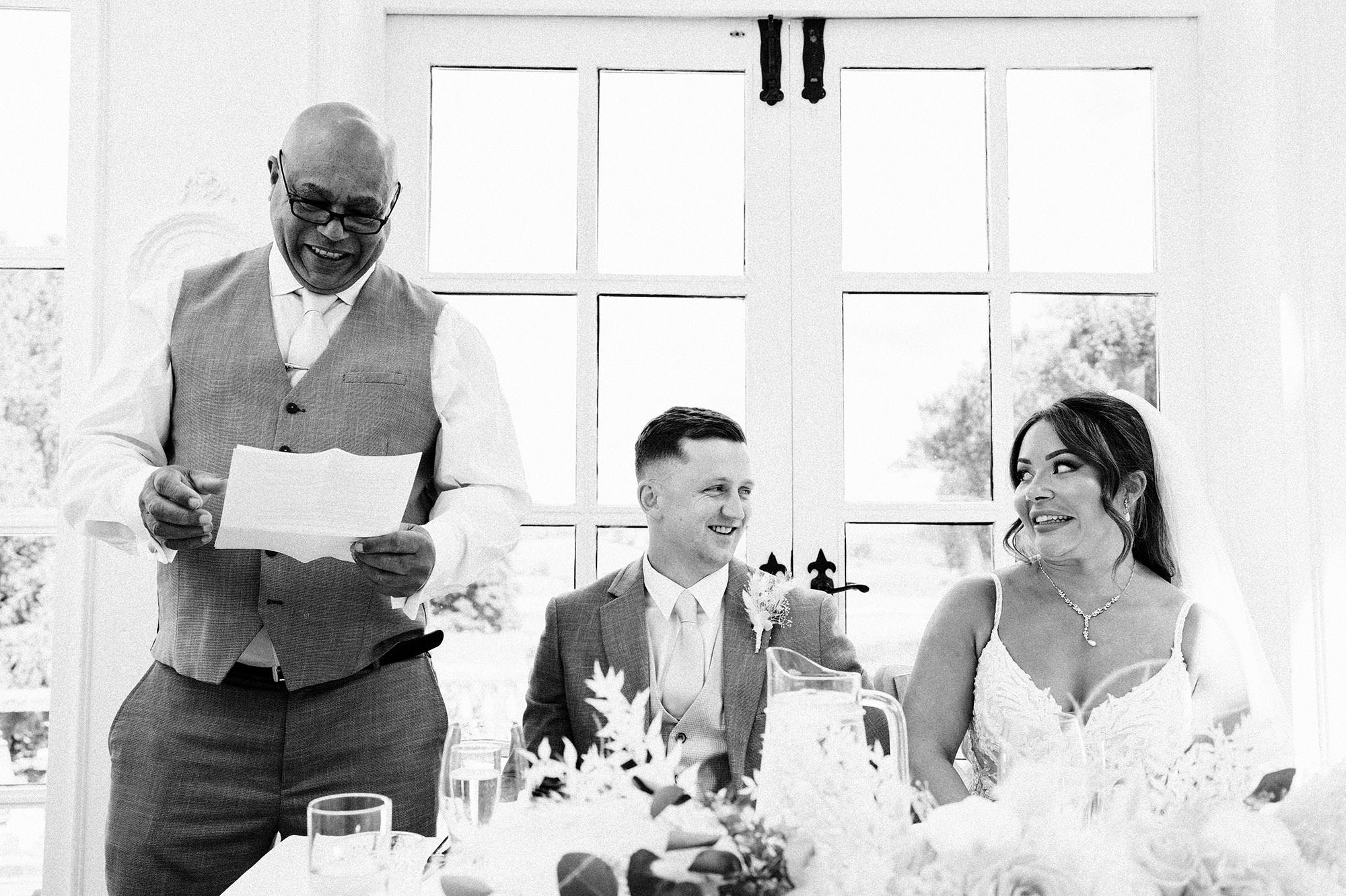 bride smiles at her dad on her wedding day