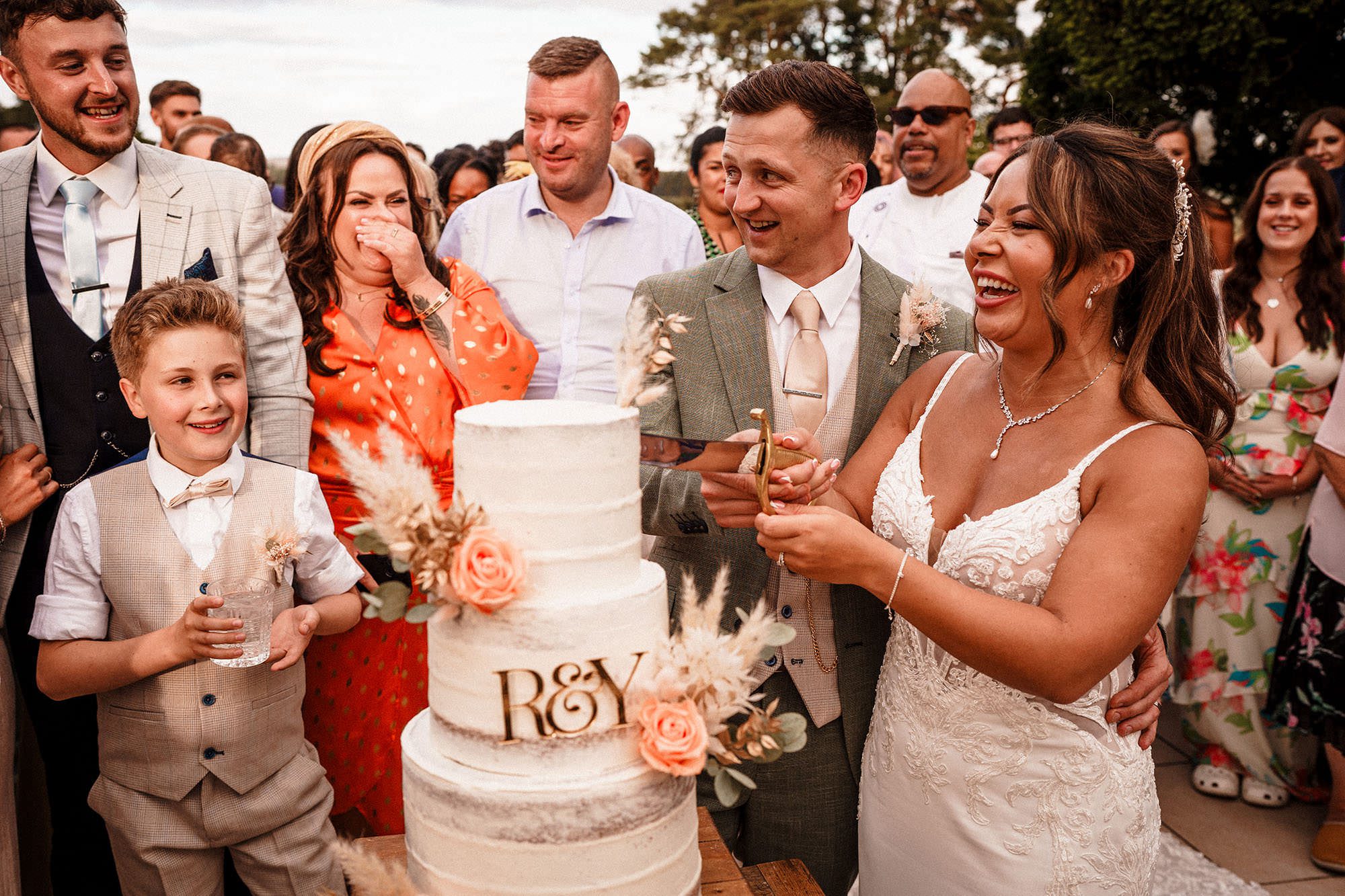 wedding cake being cut at woodhill hall