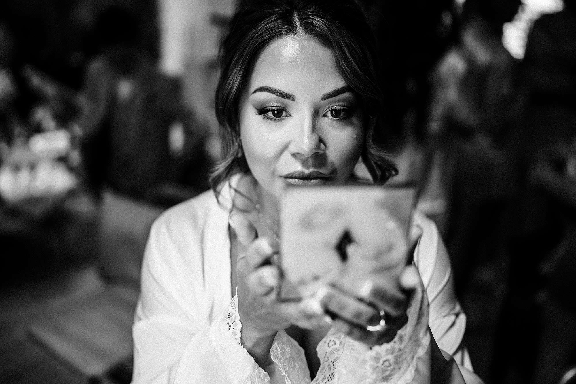 bride putting on her make up for her wedding day