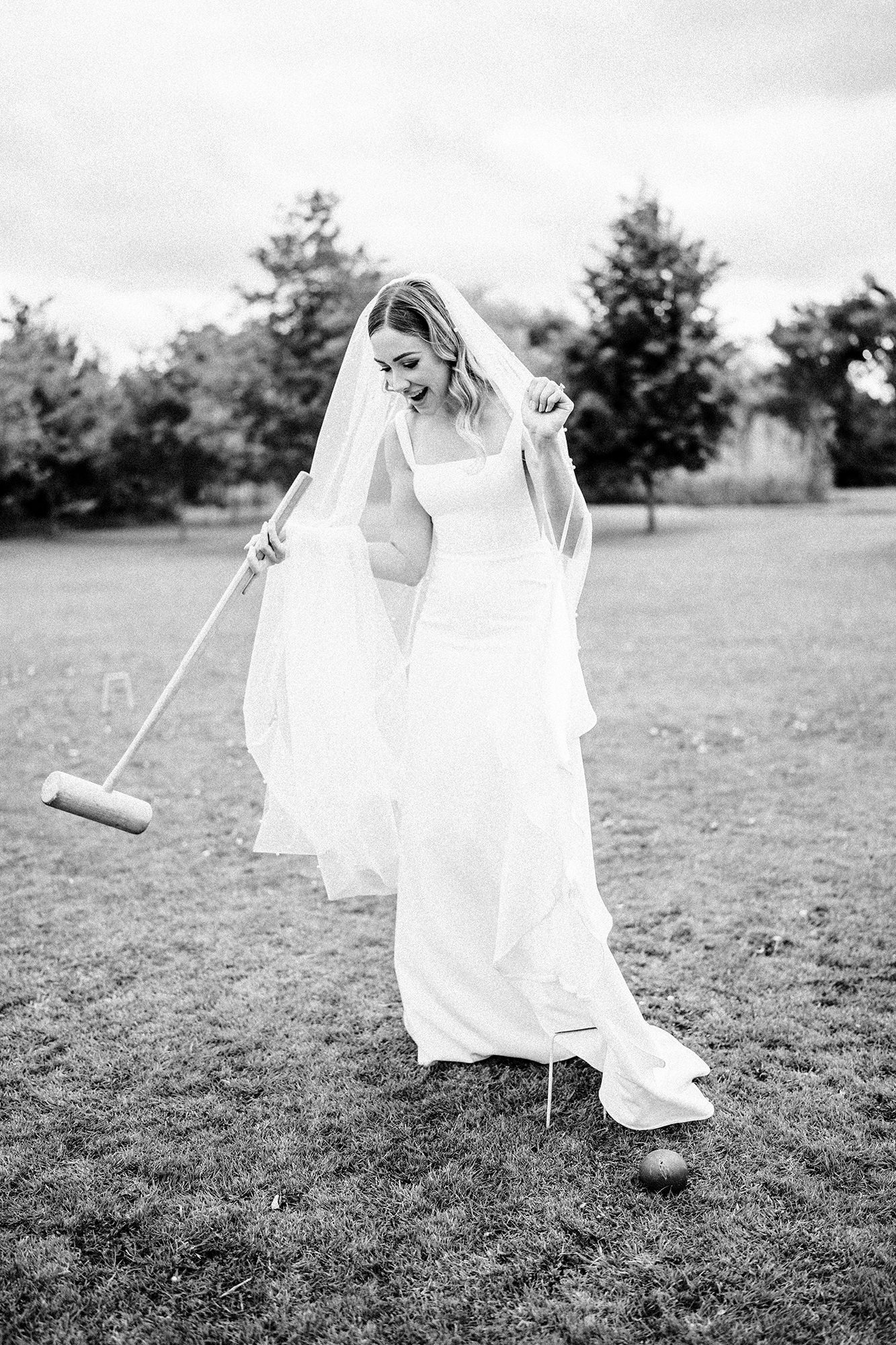 Bride playing lawn games in her dress on the grounds at Scarlett Hall in Cheshire