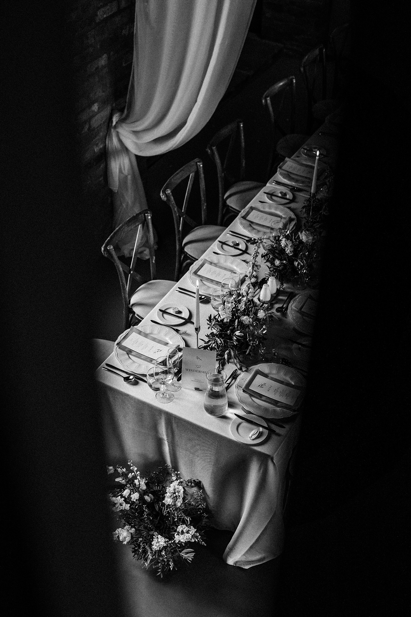 Long wedding breakfast table with place settings and flowers at Scarlett Hall in Cheshire