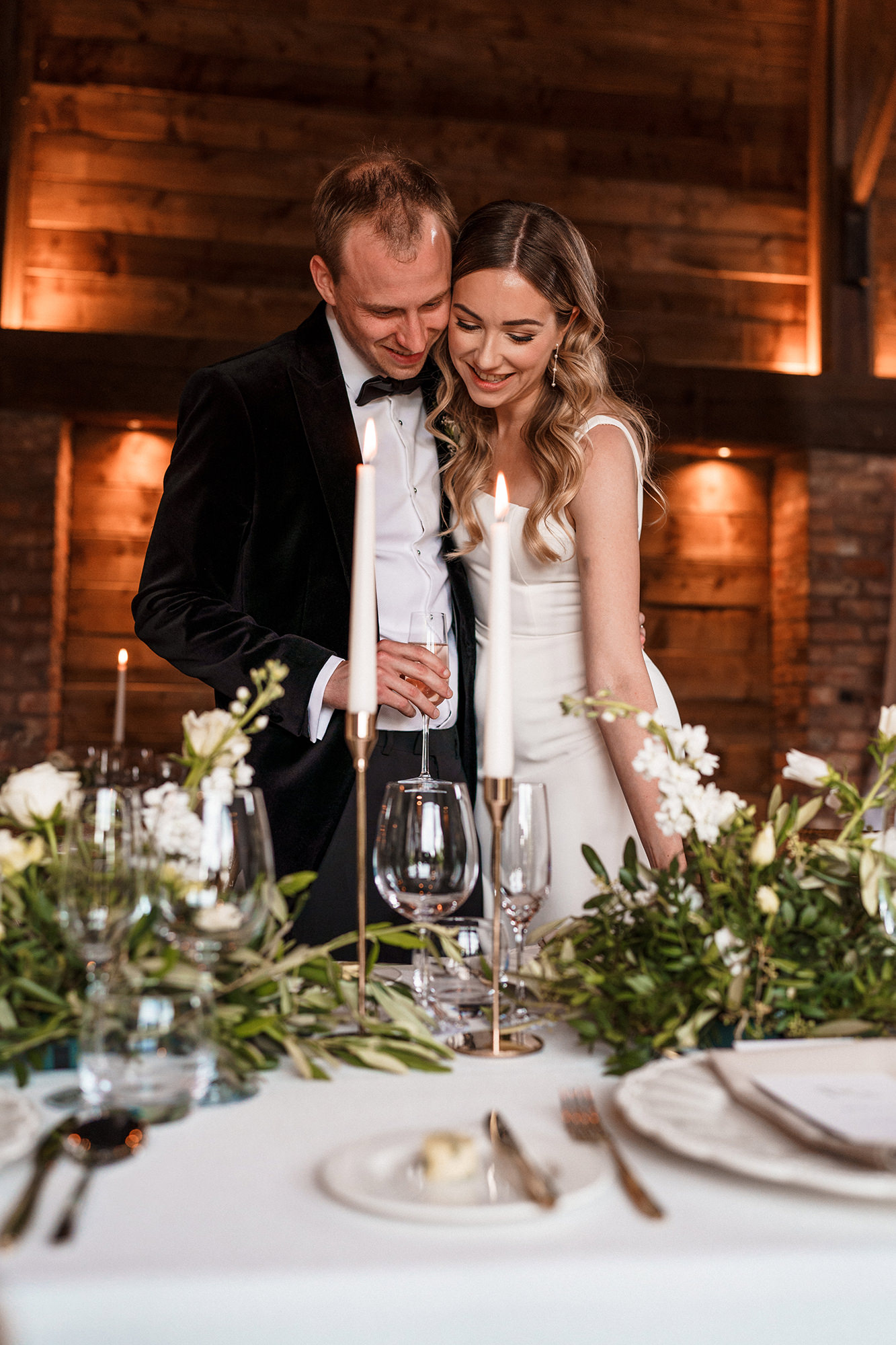 Marone and Olly by candlelight at the head table at Scarlett Hall wedding reception