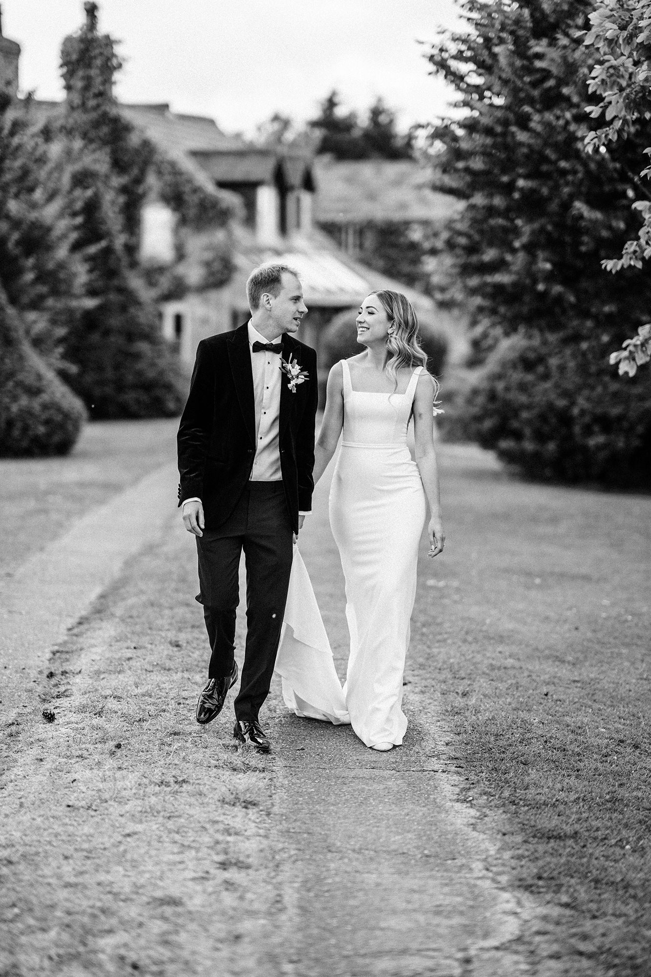 Marone and Olly walking together outside Scarlett Hall wedding venue in Cheshire