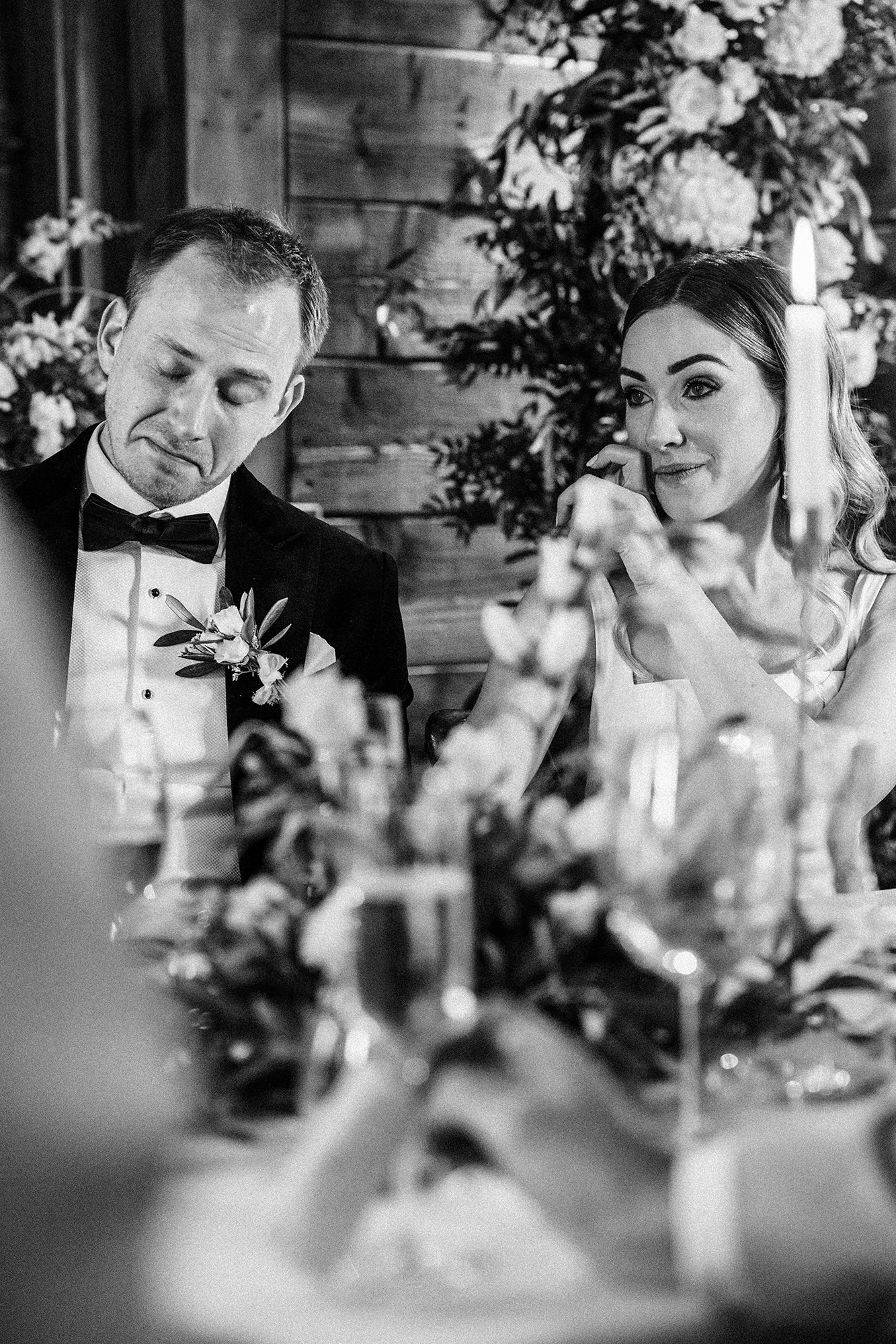 Marone and Olly listening to speeches at the wedding breakfast at Scarlett Hall