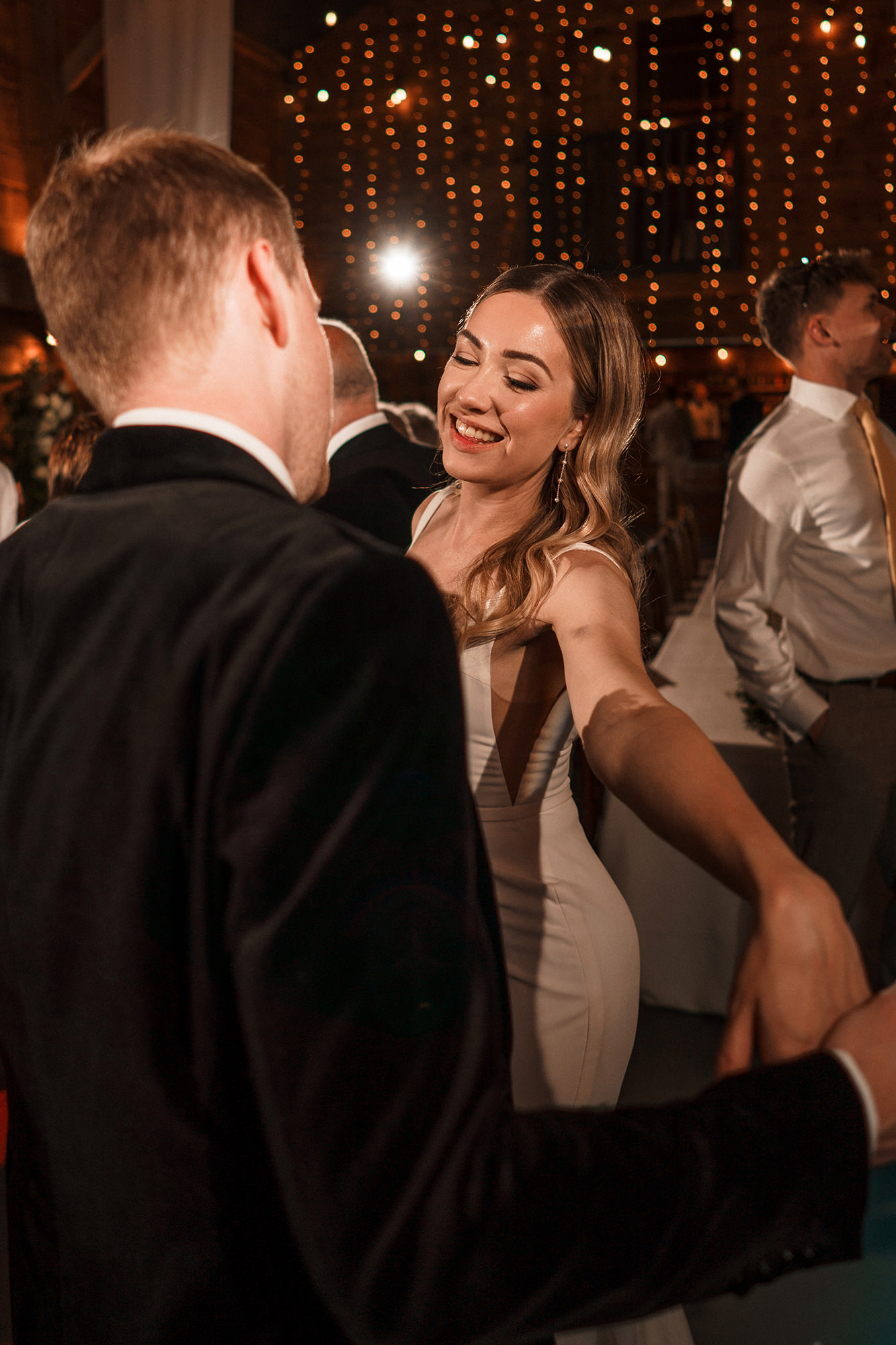 Bride dancing with guests in the evening reception at Scarlett Hall wedding in Cheshire