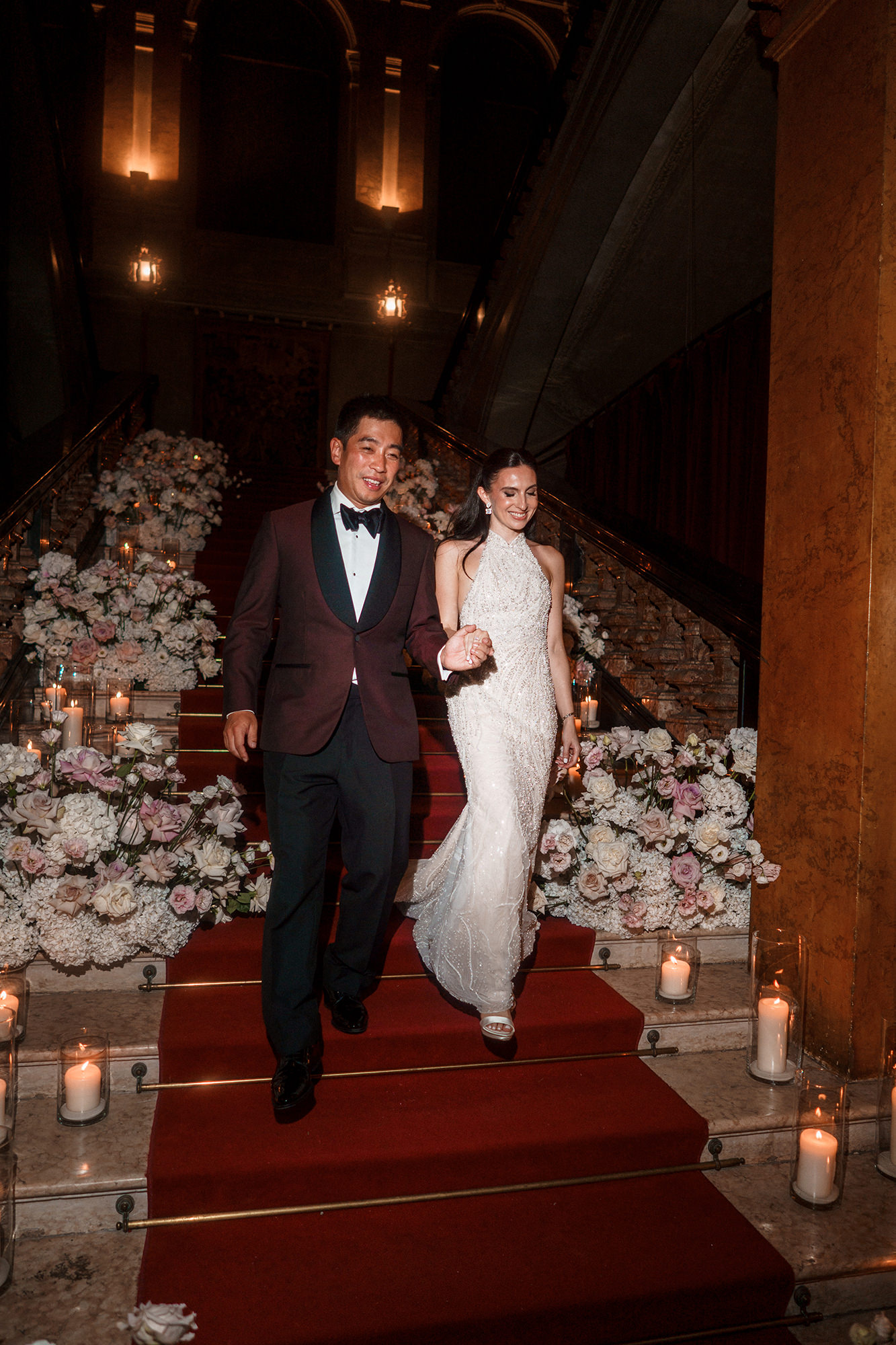 Bride and groom walking down grand staircase at Lake Como wedding