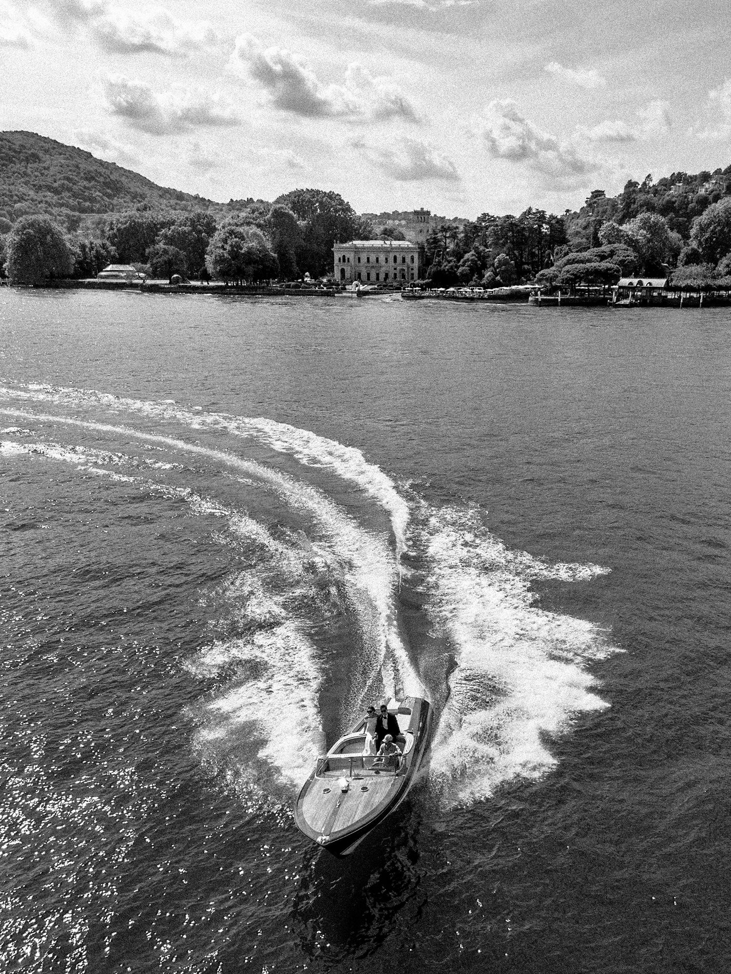 Boat on Lake Como passing a wedding villa