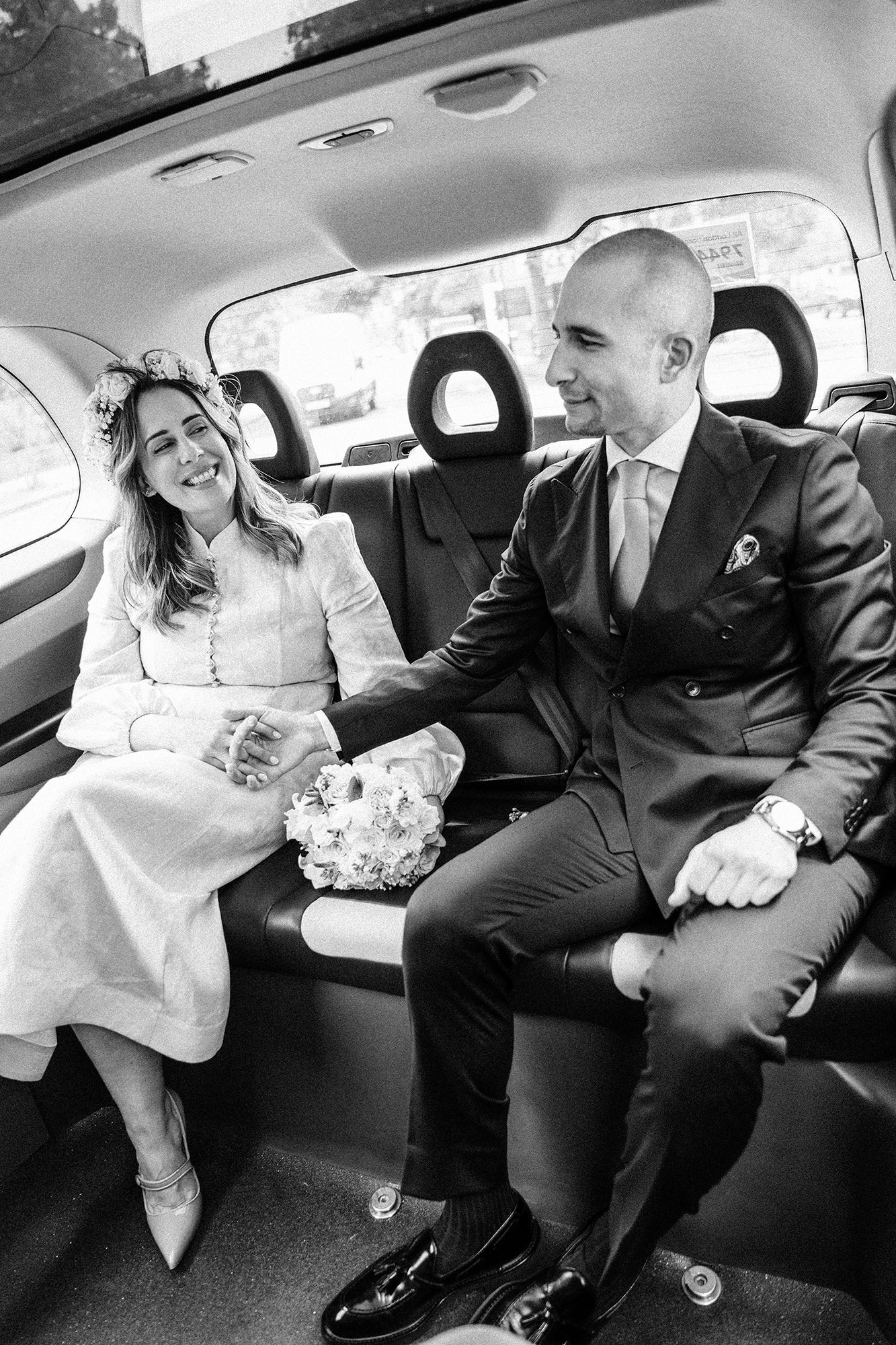 Niki and Diego travelling in a black cab on their wedding day