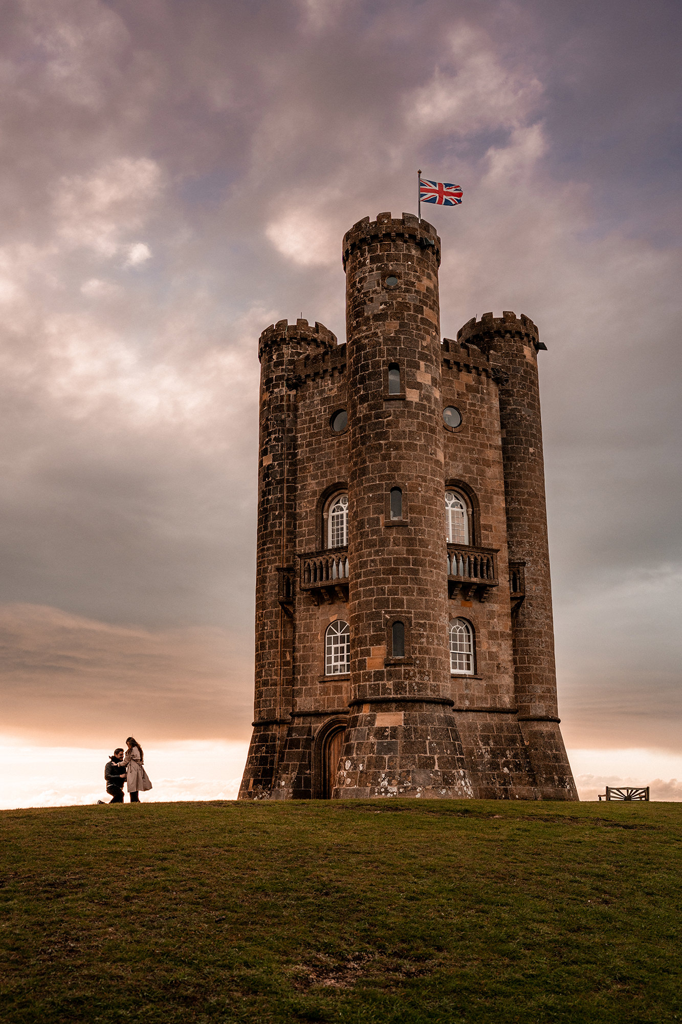 Sunset silhouette of Alfredo and Jennifer at Broadway Tower after their proposal