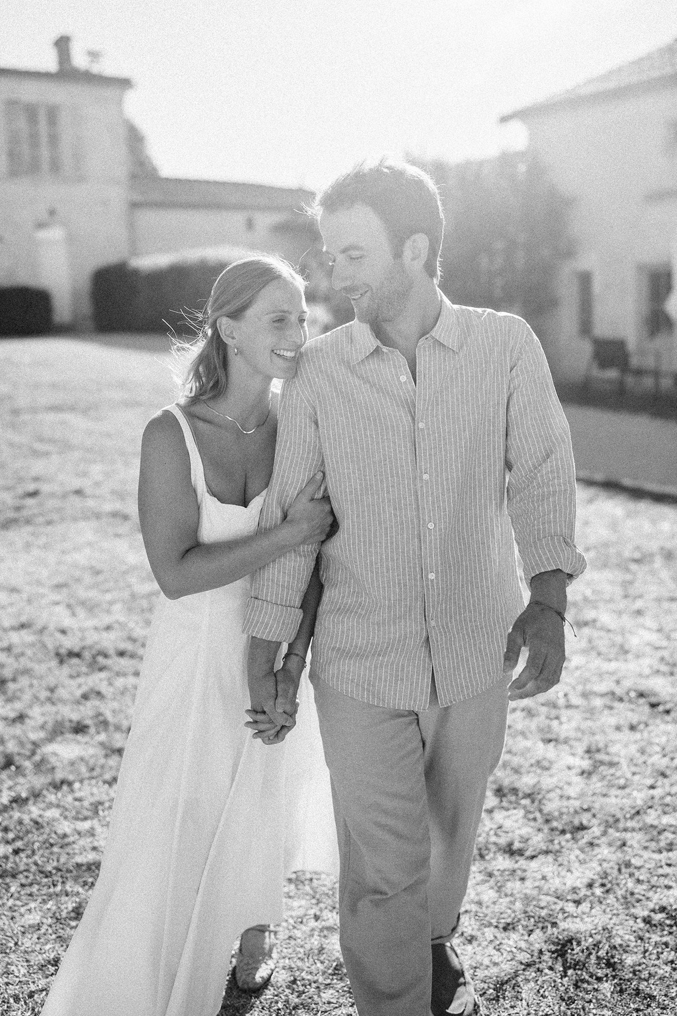 Black and white photograph of Anne-Sophie and Clément laughing together at La Cannonerie