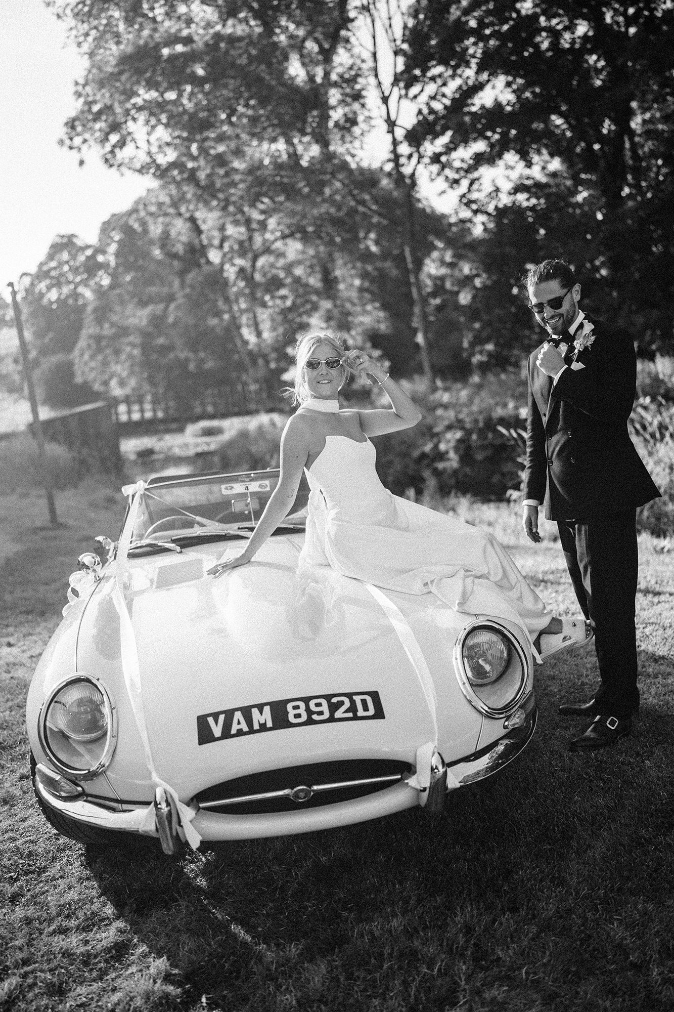 Bride and groom with a classic wedding car in the French countryside