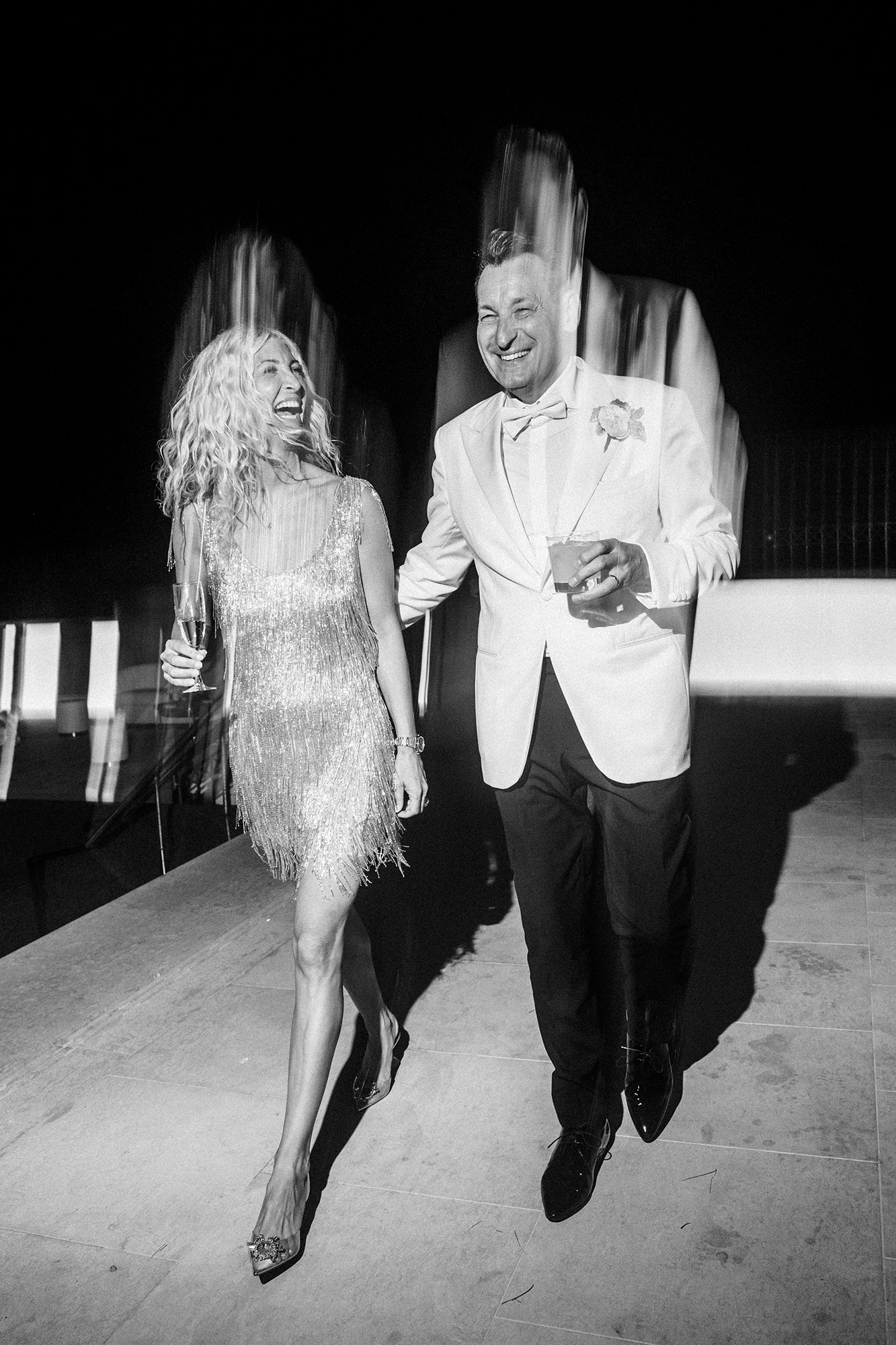 Couple laughing together during an evening wedding celebration