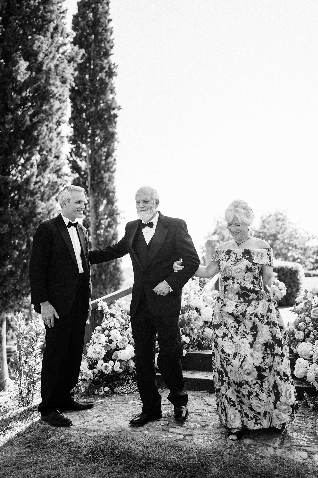 Family members walking together during an outdoor wedding ceremony in France