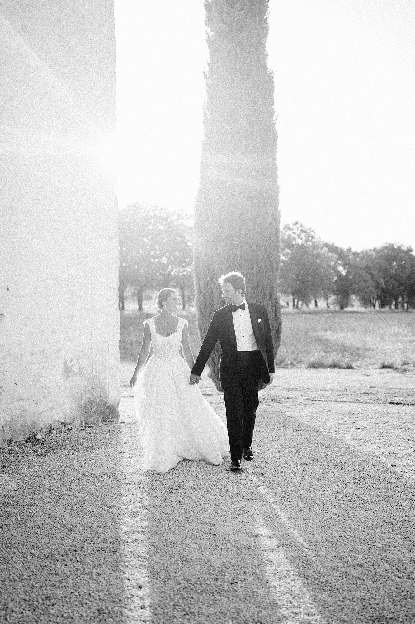 Wedding couple walking together in soft French evening light