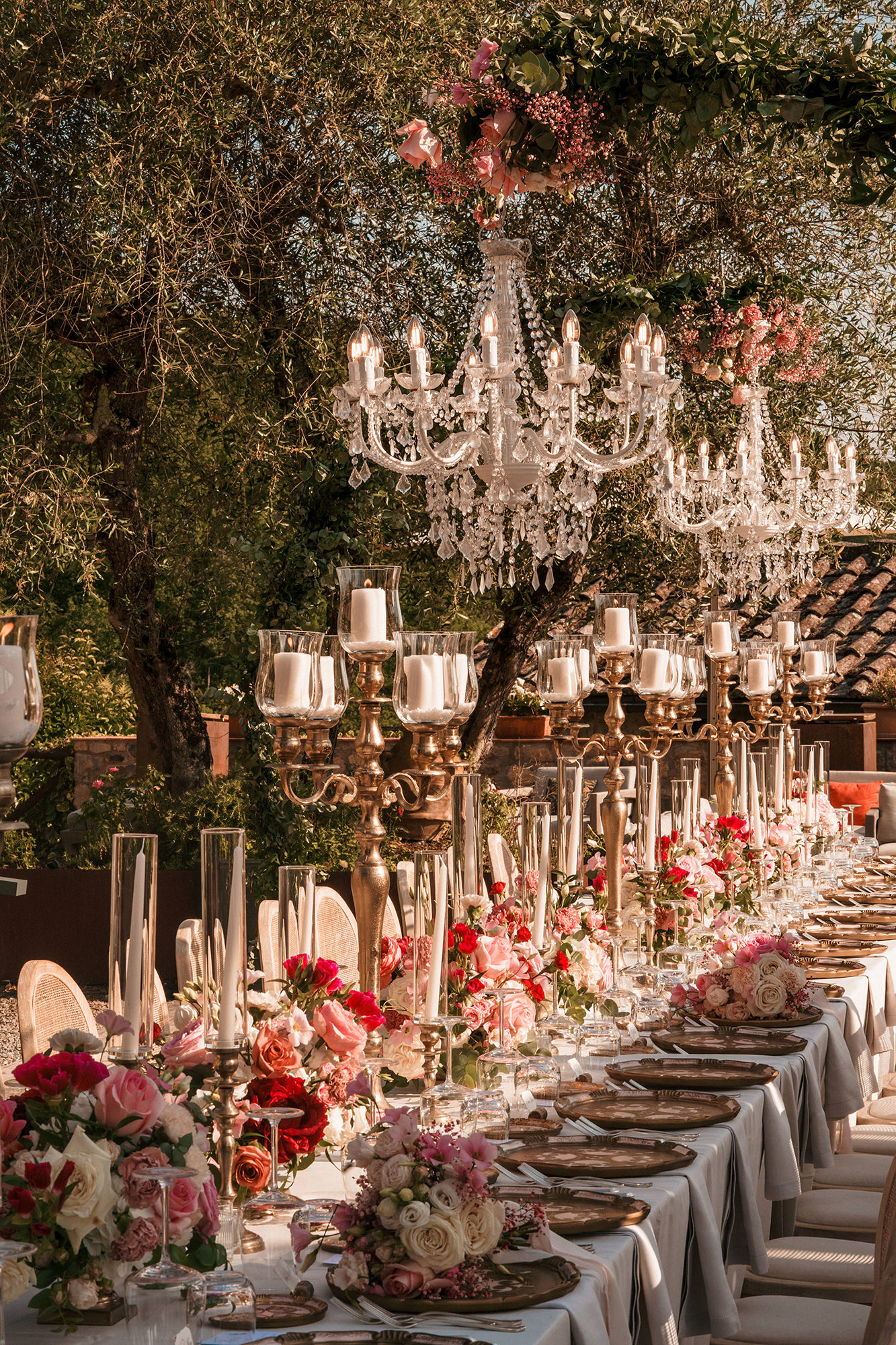 Al fresco French wedding dinner with flowers, candles and chandeliers